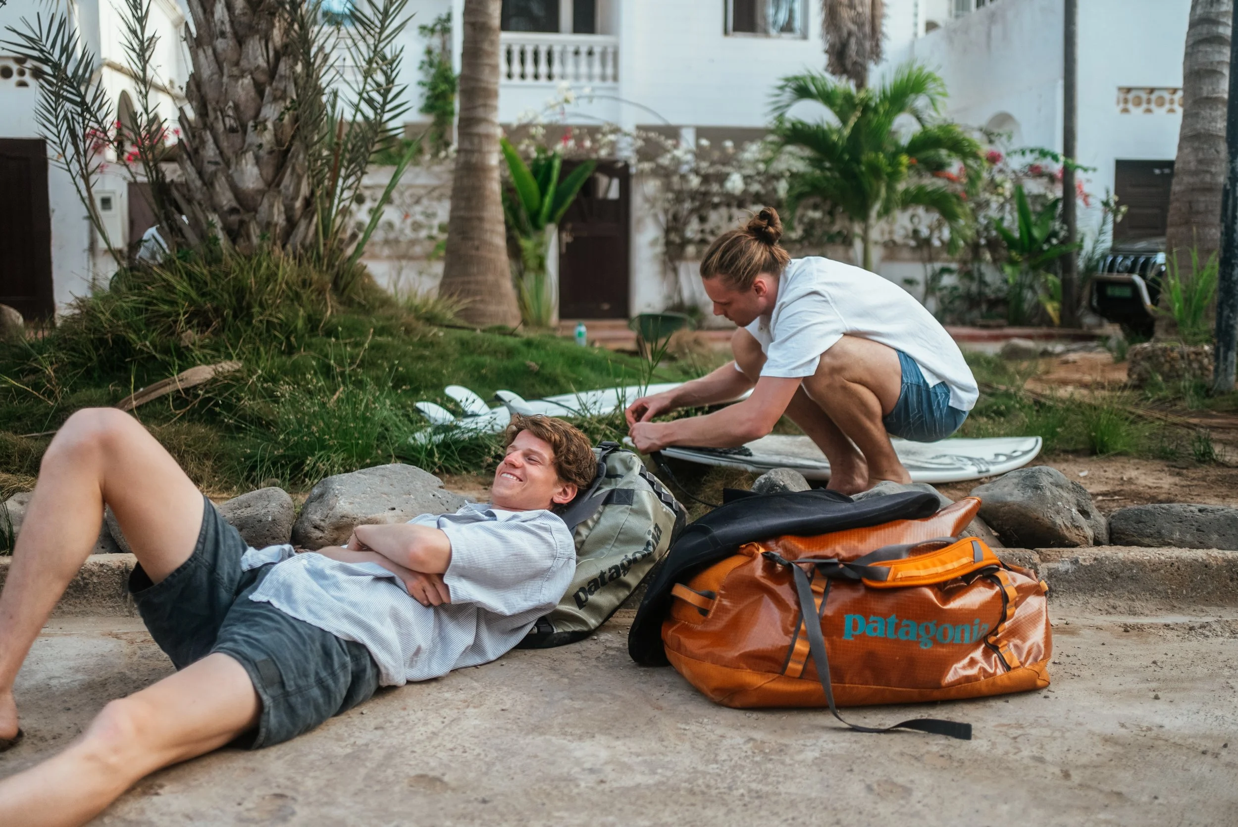two men on a surf trip with their Patagonia bags