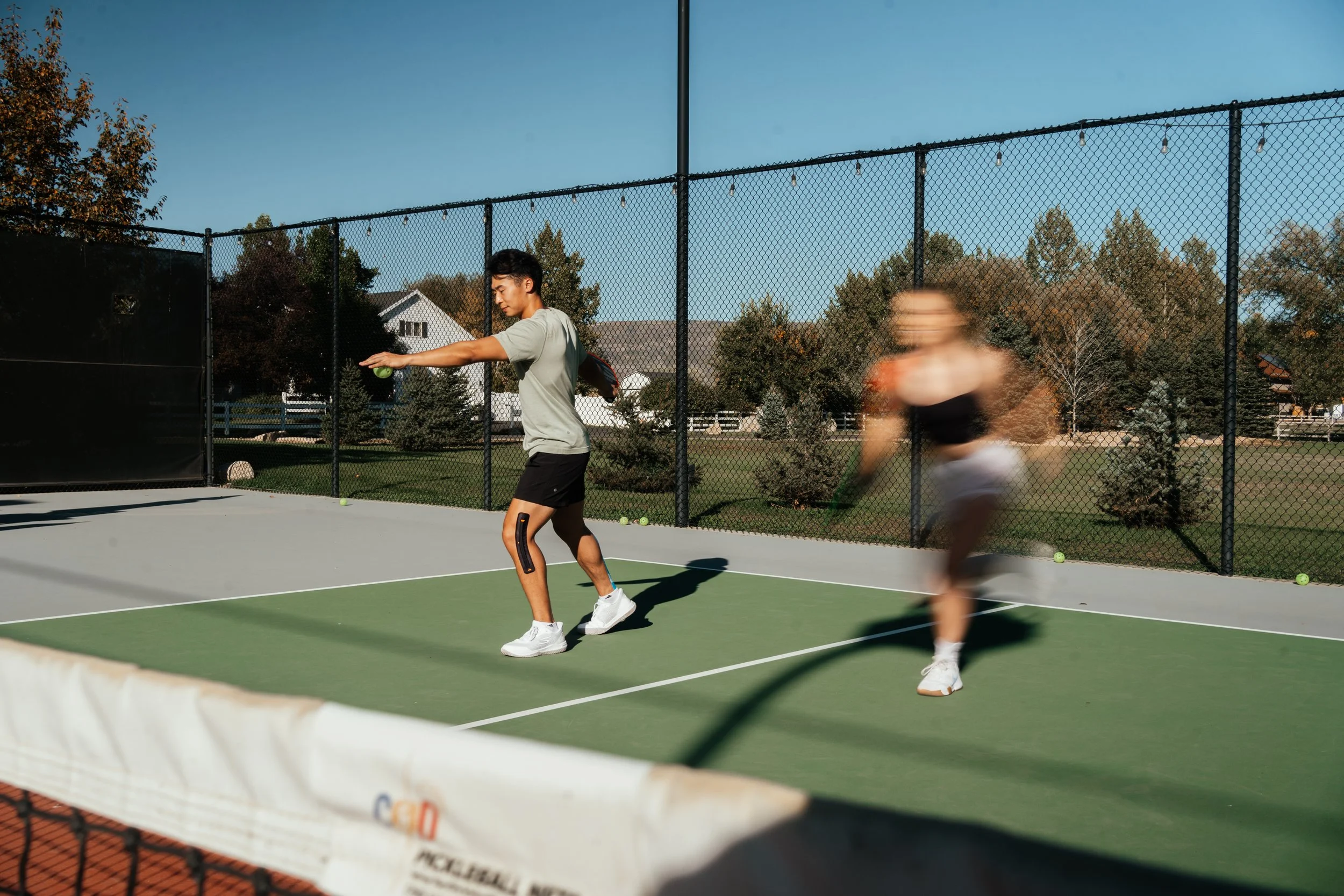 long exposure photo of a man serving in pickleball