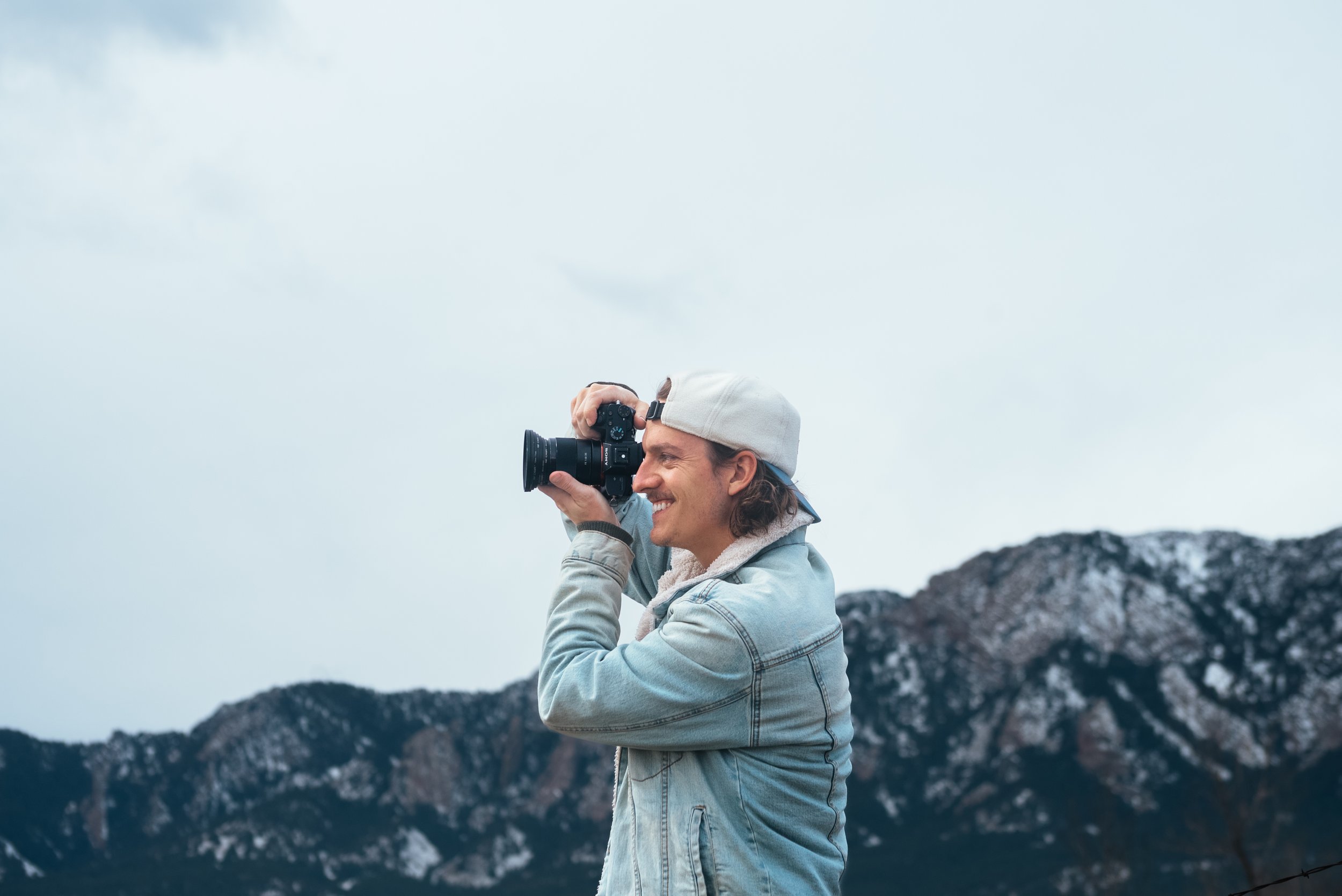 Roo smith holding a camera and photographing in Boulder, Colorado
