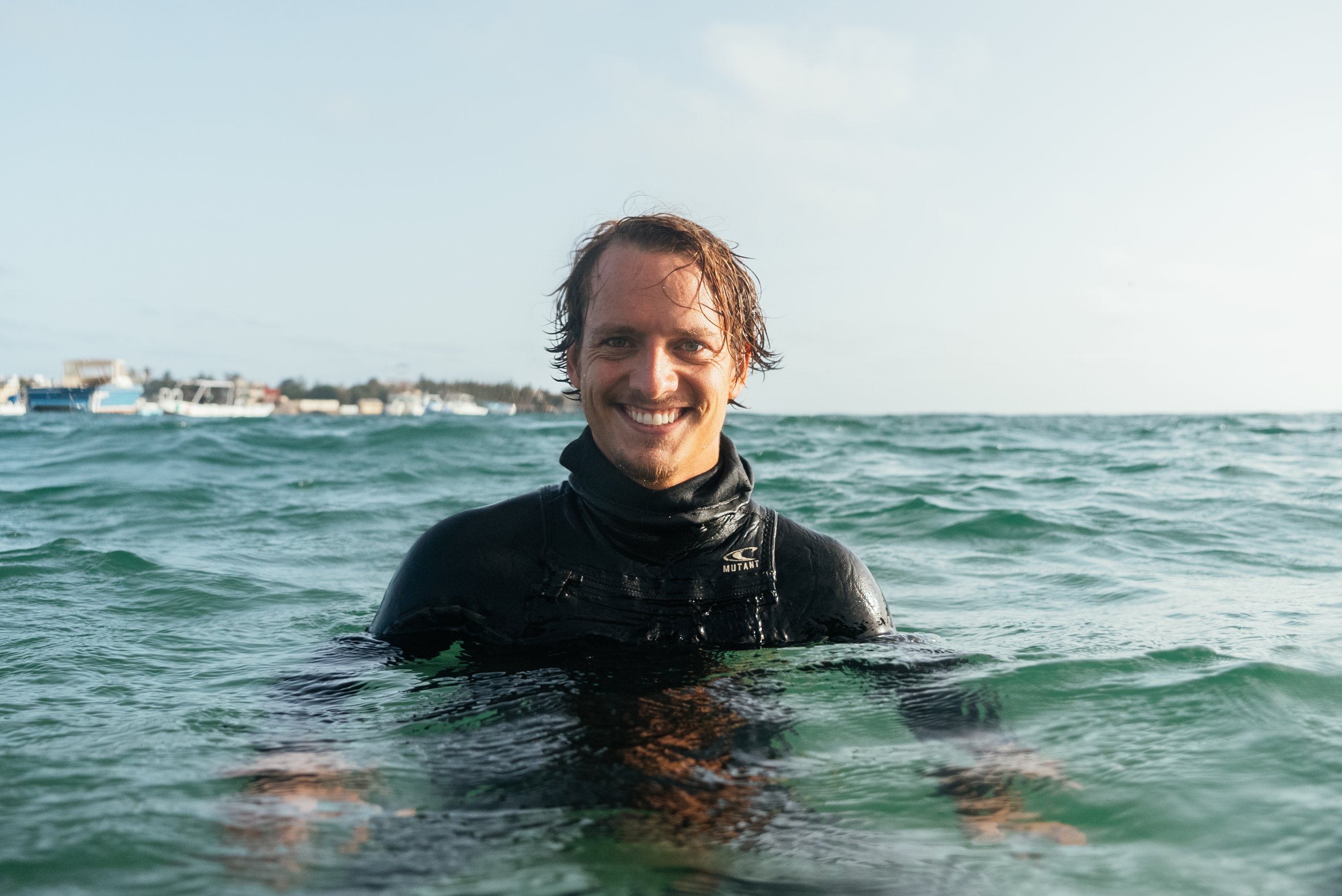 Roo Smith in wetsuit in the ocean smiling