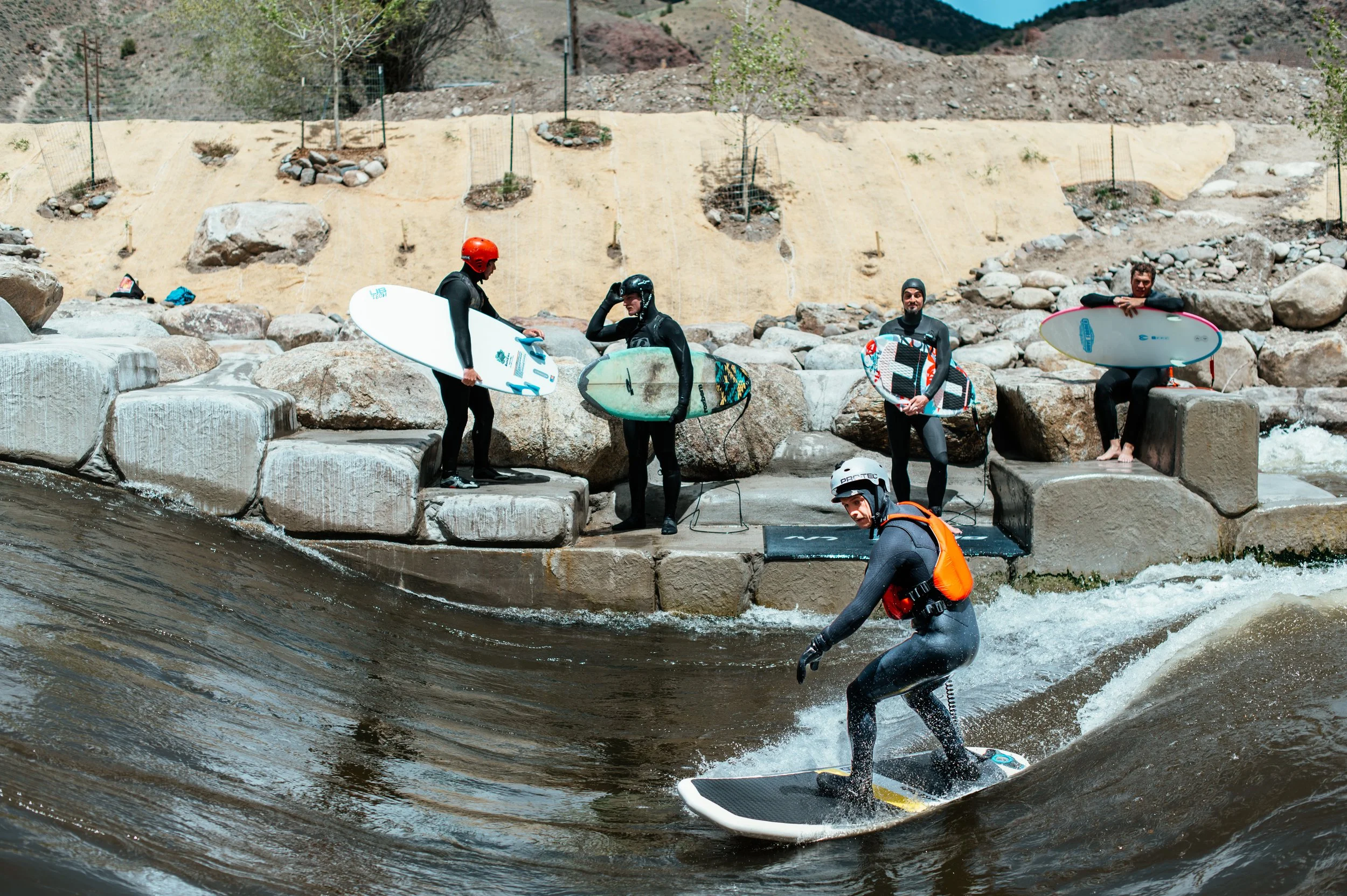 group of surfers in Colorado river surfing