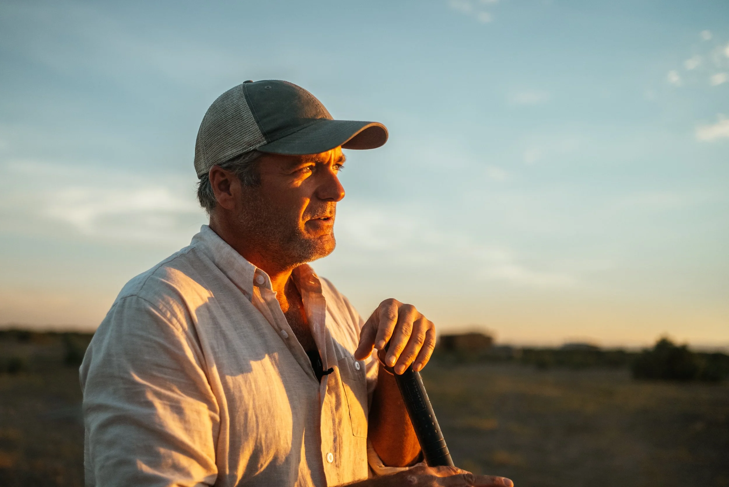 farmer posing at sunset
