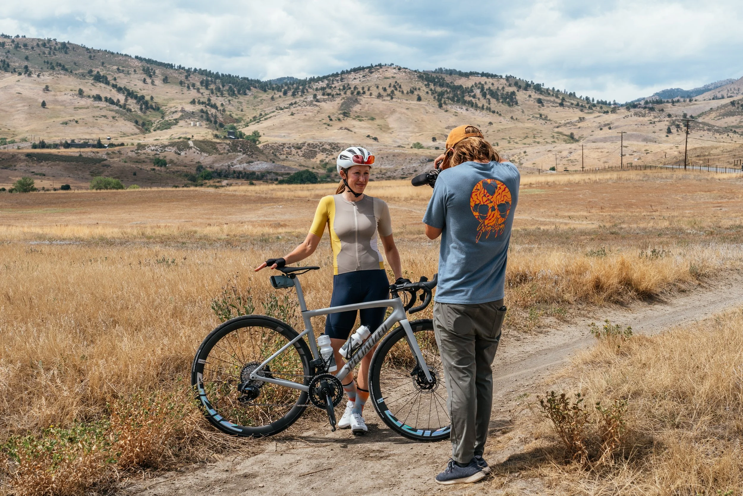 behind-the-scenes photo of Roo Smith photographing a professional cyclist