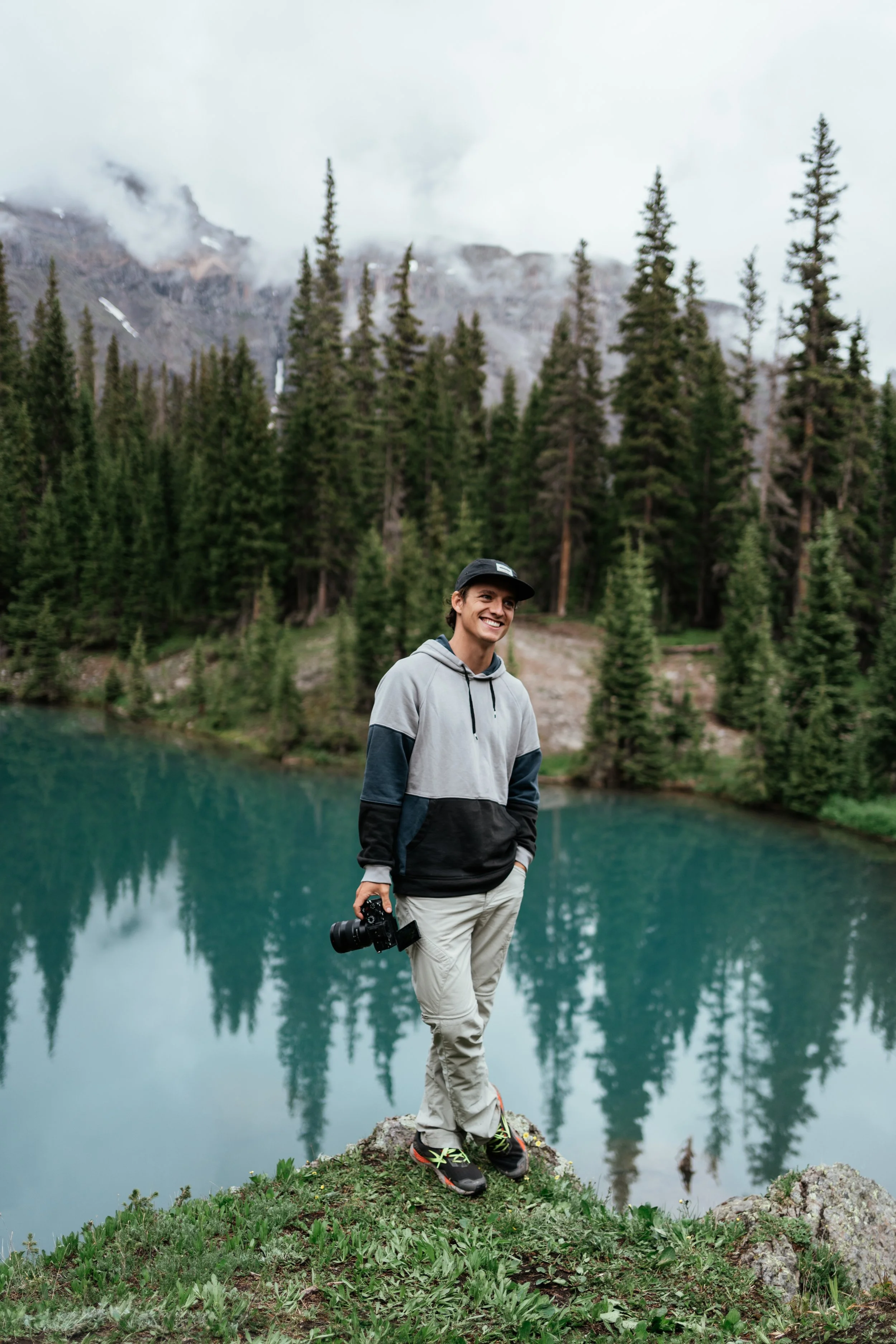 Roo holding camera in the mountains