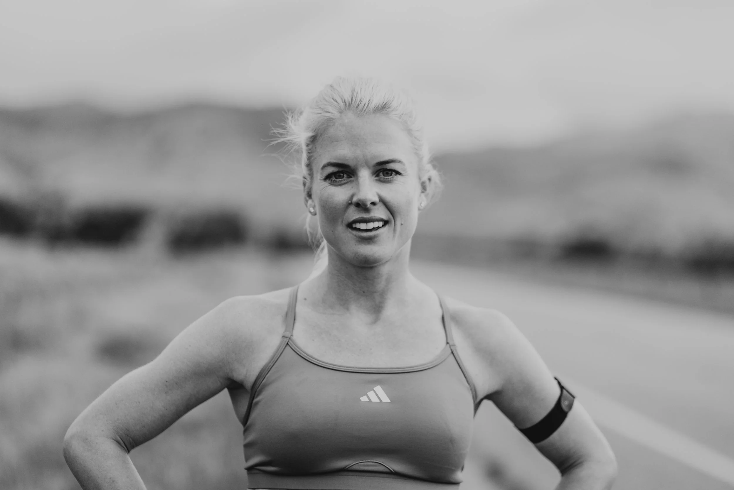 black and white photo of female runner looking at camera