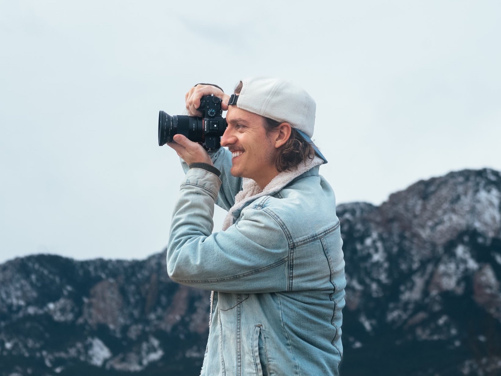 Adventure photographer Roo Smith smiling while holding a camera