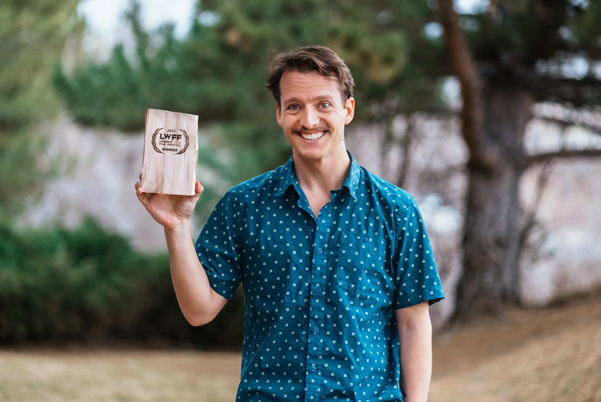 Roo holding his award from lookout wild film festival