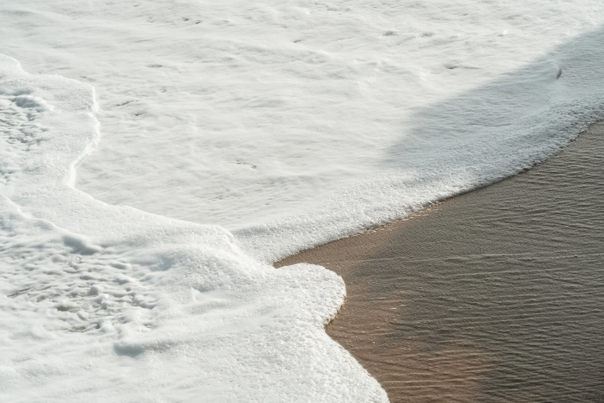 Waves washing onto a sandy beach.