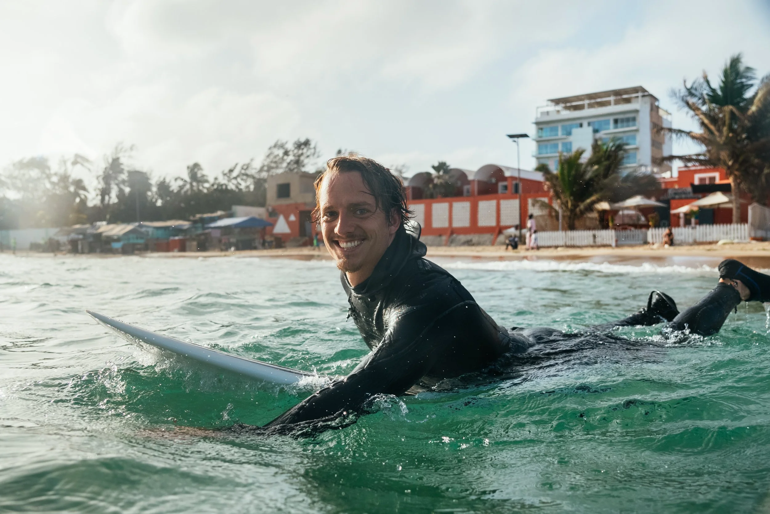 Roo surfing smiling in Senegal.