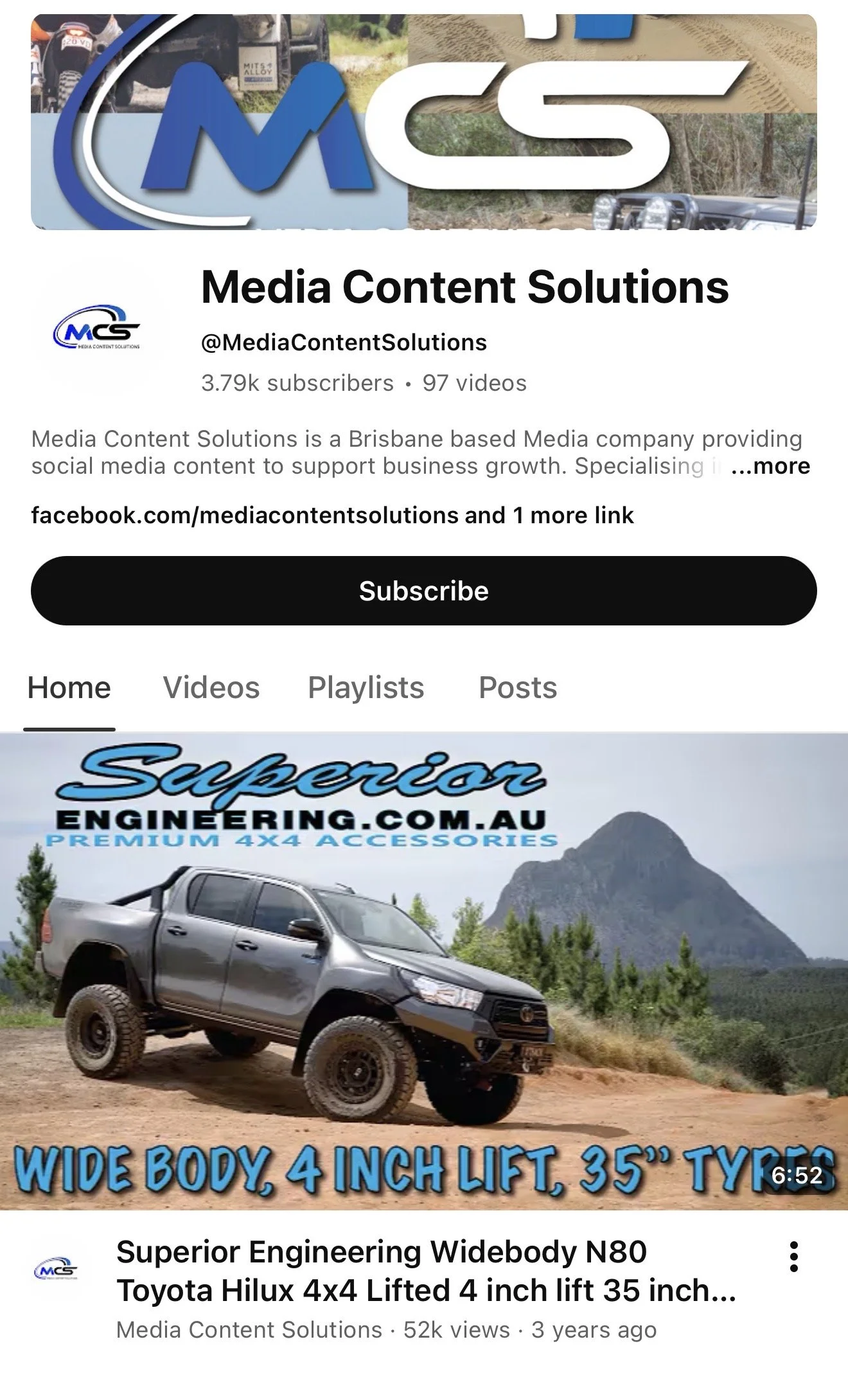YouTube thumbnail featuring a black lifted Toyota Hilux 4x4 off-road vehicle with large mud tires, set against a scenic background with mountains and trees, and text that highlights its wide body, 4 inch lift, and 35 inch tires.