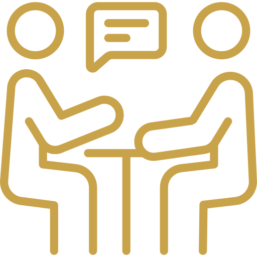 Two people sitting at a table having a conversation, with speech bubbles above their heads.