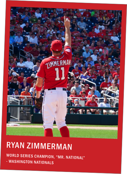 Ryan Zimmerman of the Washington Nationals on the baseball field raising his right hand as fans watch from the stadium stands.