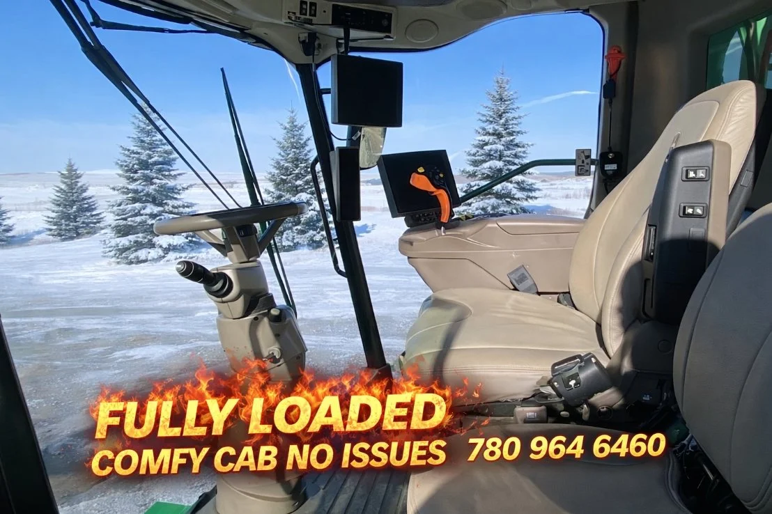 Inside a fully loaded snowplow or similar vehicle with a snowy landscape and pine trees visible through the windshield.