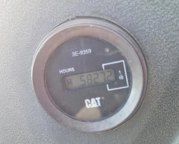 Close-up of a CAT equipment hour meter displaying 5827.2 hours.