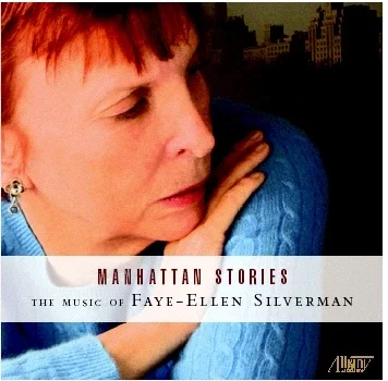 Close-up of a Faye-Ellen Silverman with short reddish hair and earrings, resting her head on her hand, looking to the side.