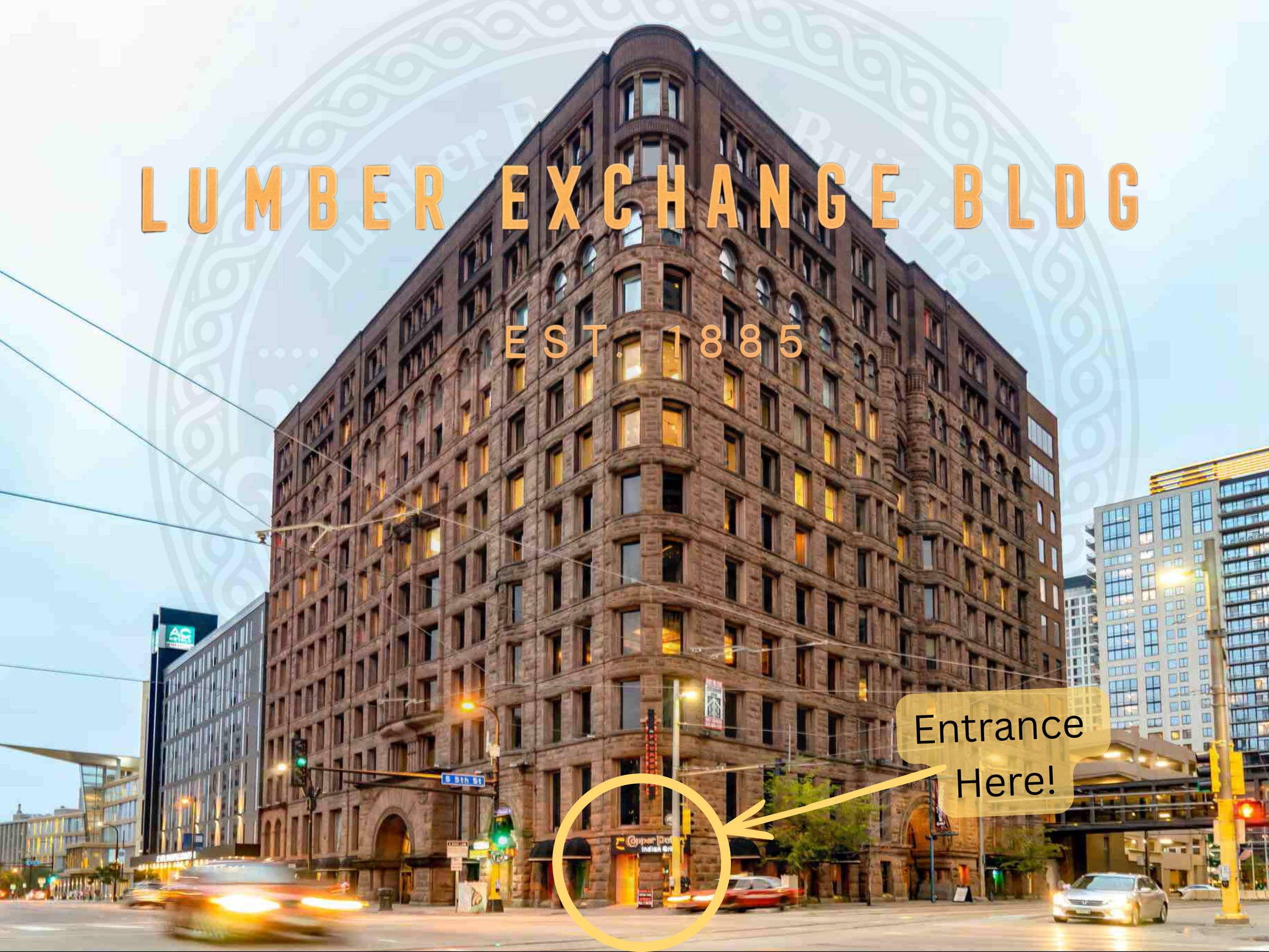 Historic brick building named Lumber Exchange Building, established in 1885, at street corner with traffic and surrounding modern skyscrapers, marked with an arrow and note indicating the entrance.