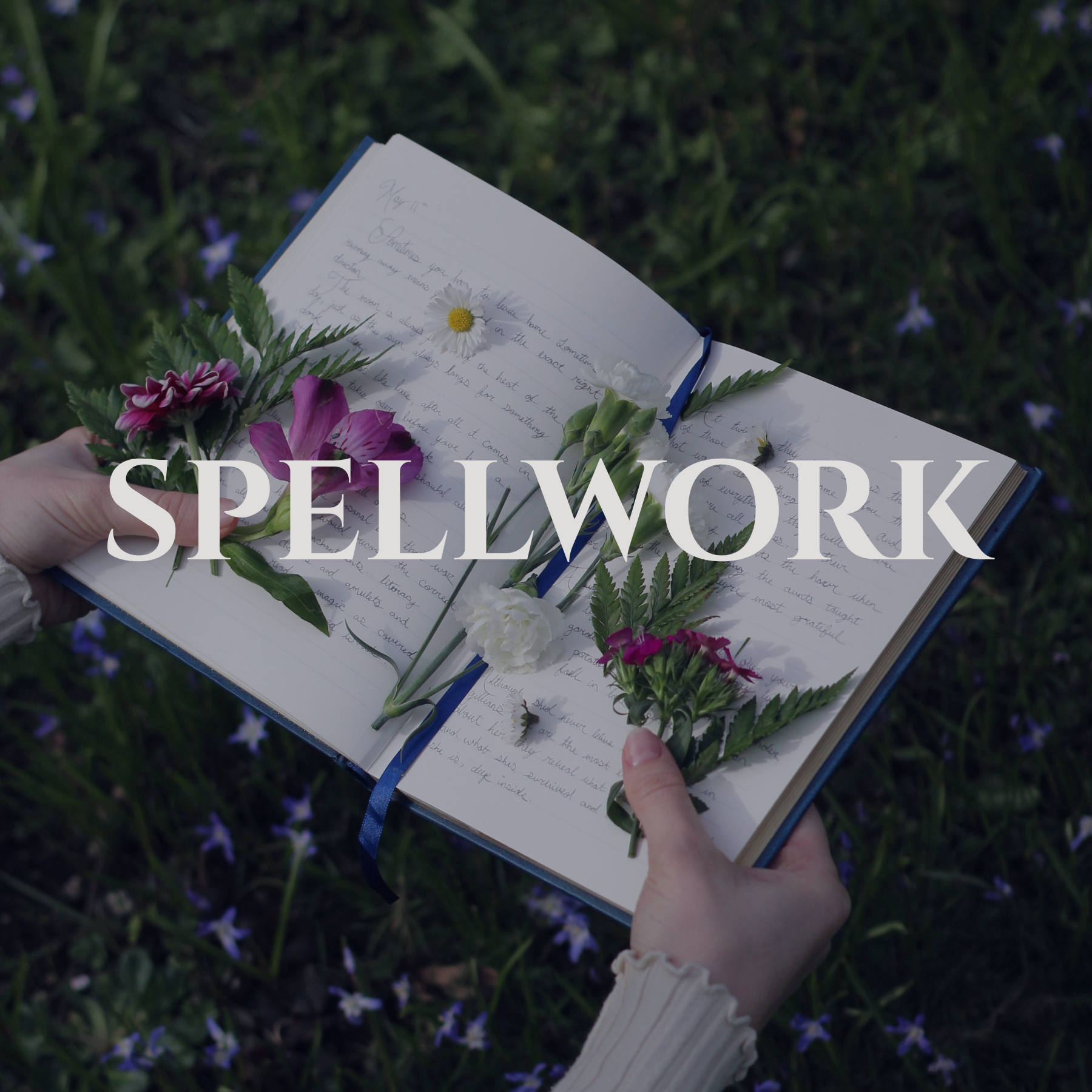 A person holding an open notebook with handwritten text, surrounded by various flowers including daisies and pink flowers, outdoors on grass with small purple flowers in the background. The word 'SPELLWORK' is overlaid in large white letters.