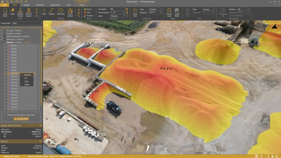 3D model of a construction site showing piles of materials in yellow and red, with labels such as Pile #3 and Pile #10, surrounded by dirt roads, construction vehicles, and equipment within a virtual landscape software interface.