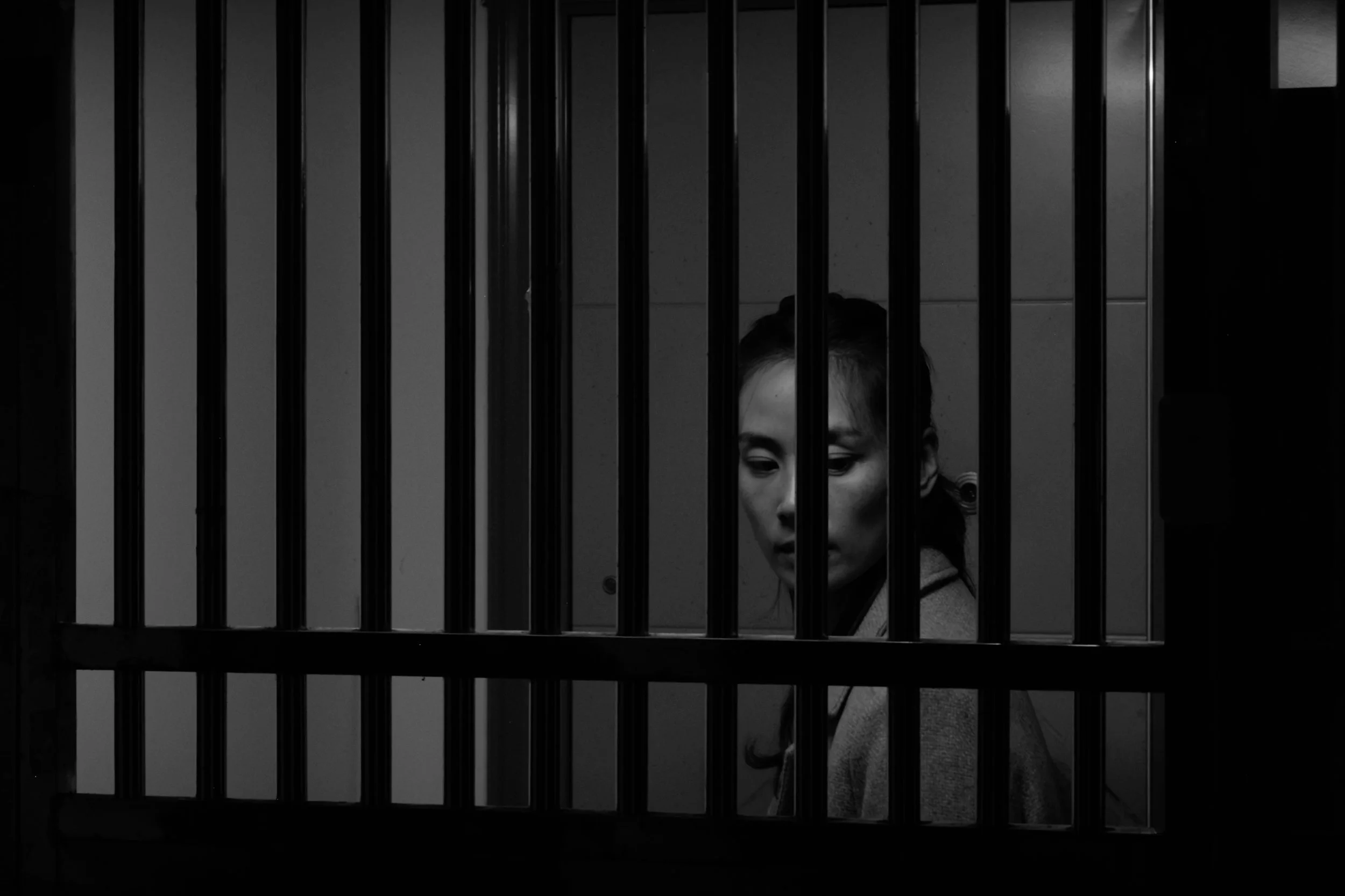 Y leaving her gated door in the film Pigs in Heaven. A black and white photo.