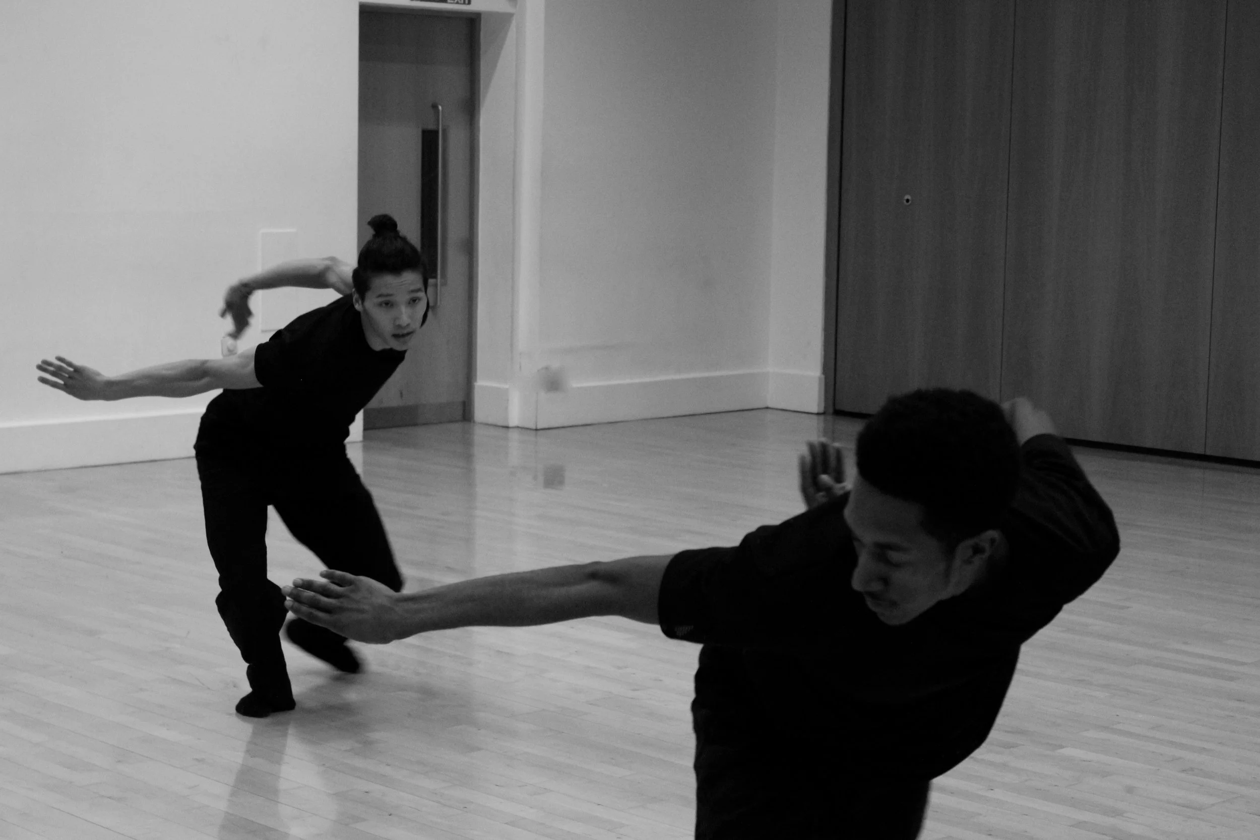 Kenny Ho and Ihsaan De Banya, dancing in unison. From the choreography Casting Shadows.