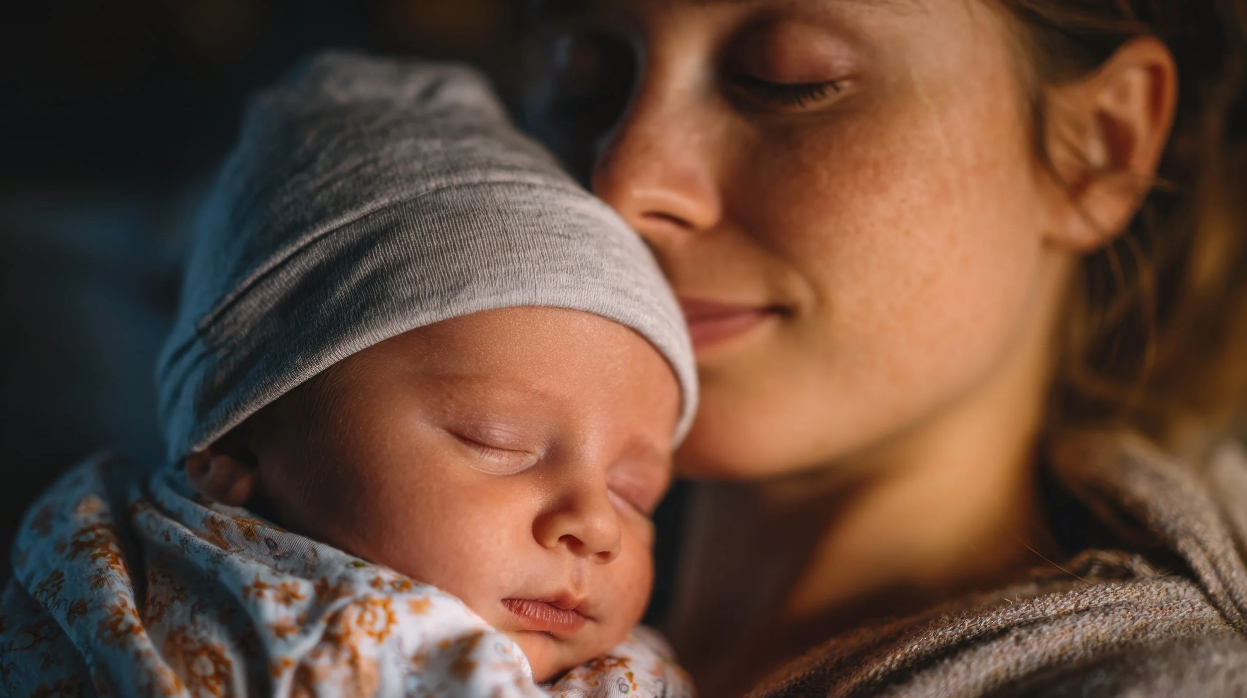 Newly born baby hugged by mother in a very calming view.