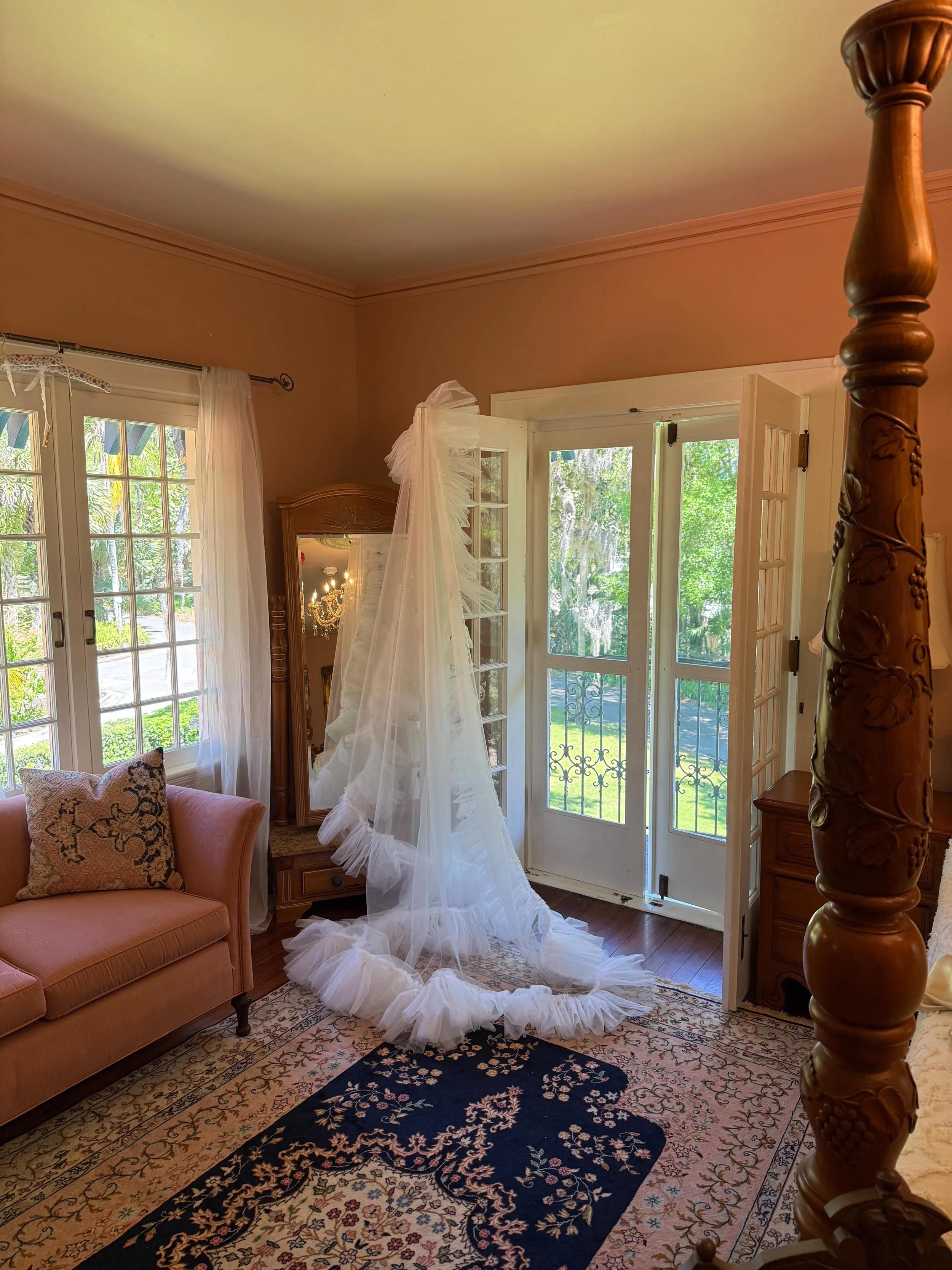 wedding dress hanging on a door frame