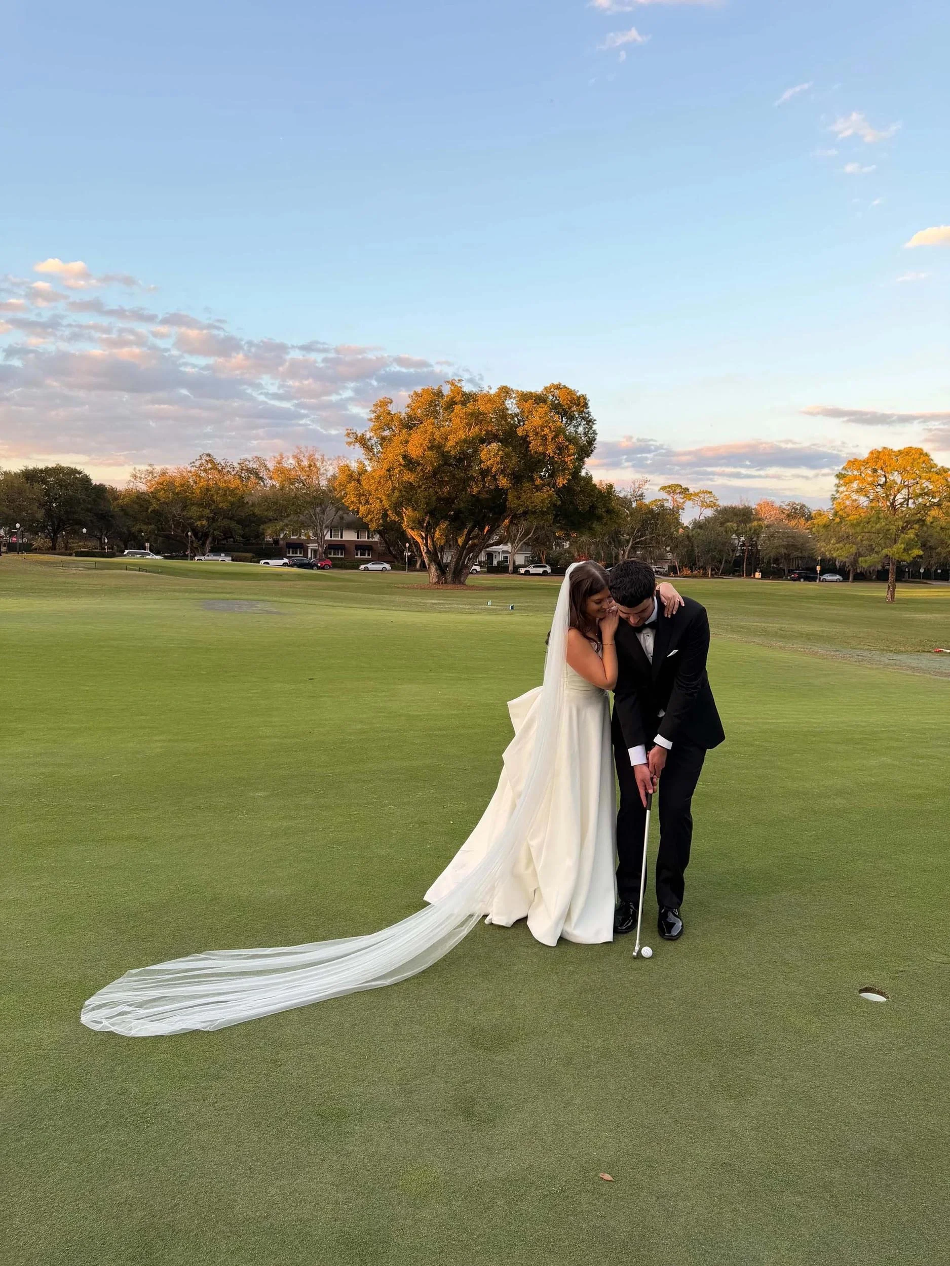 bride and groom on a gold course