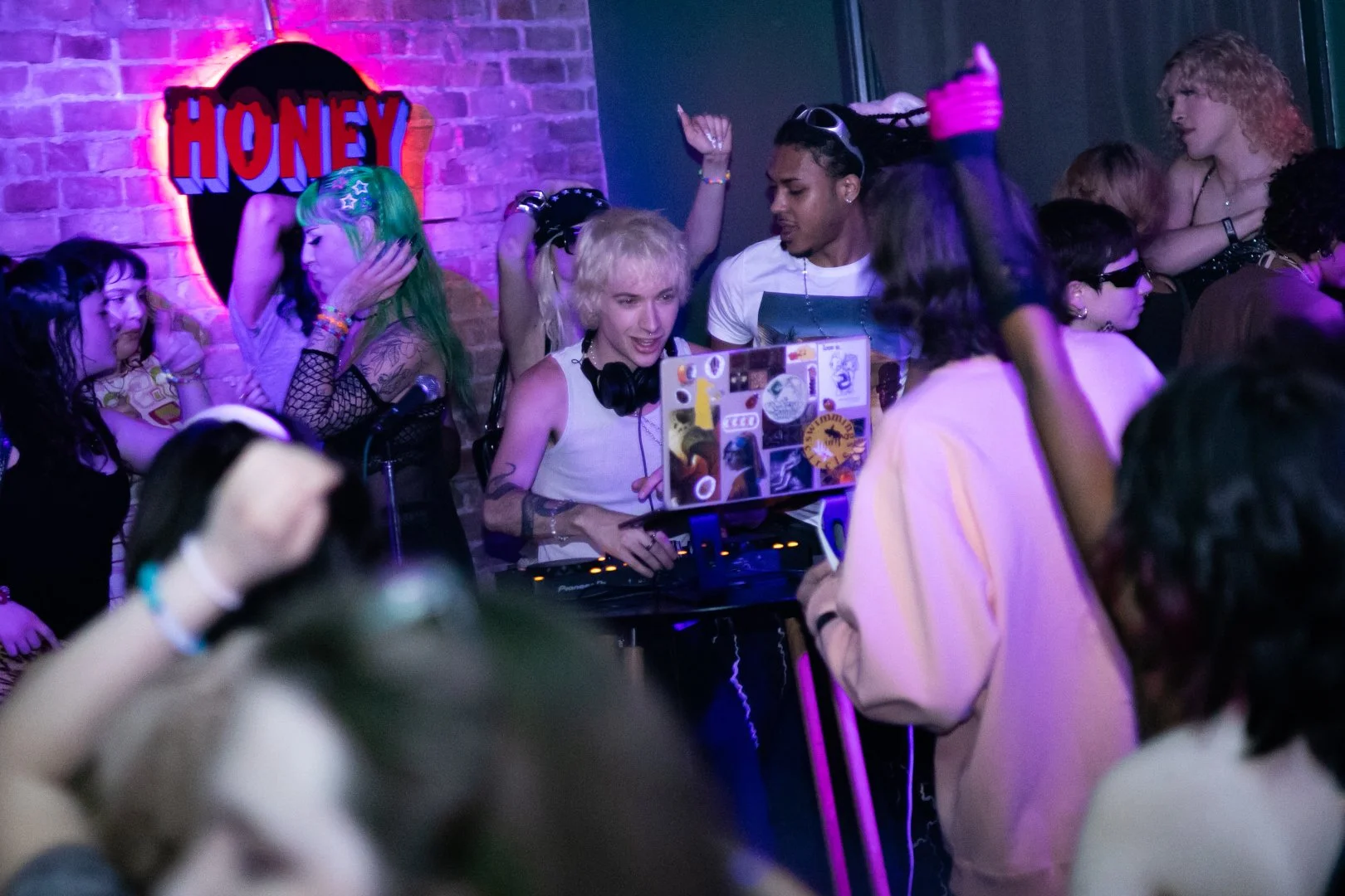 Dancers surround a DJ at hyperpop night. Photo by Justice Bekke.