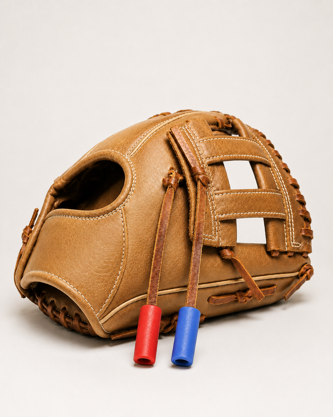 Brown baseball glove displaying red and blue GnawGear ChewLace tubes.