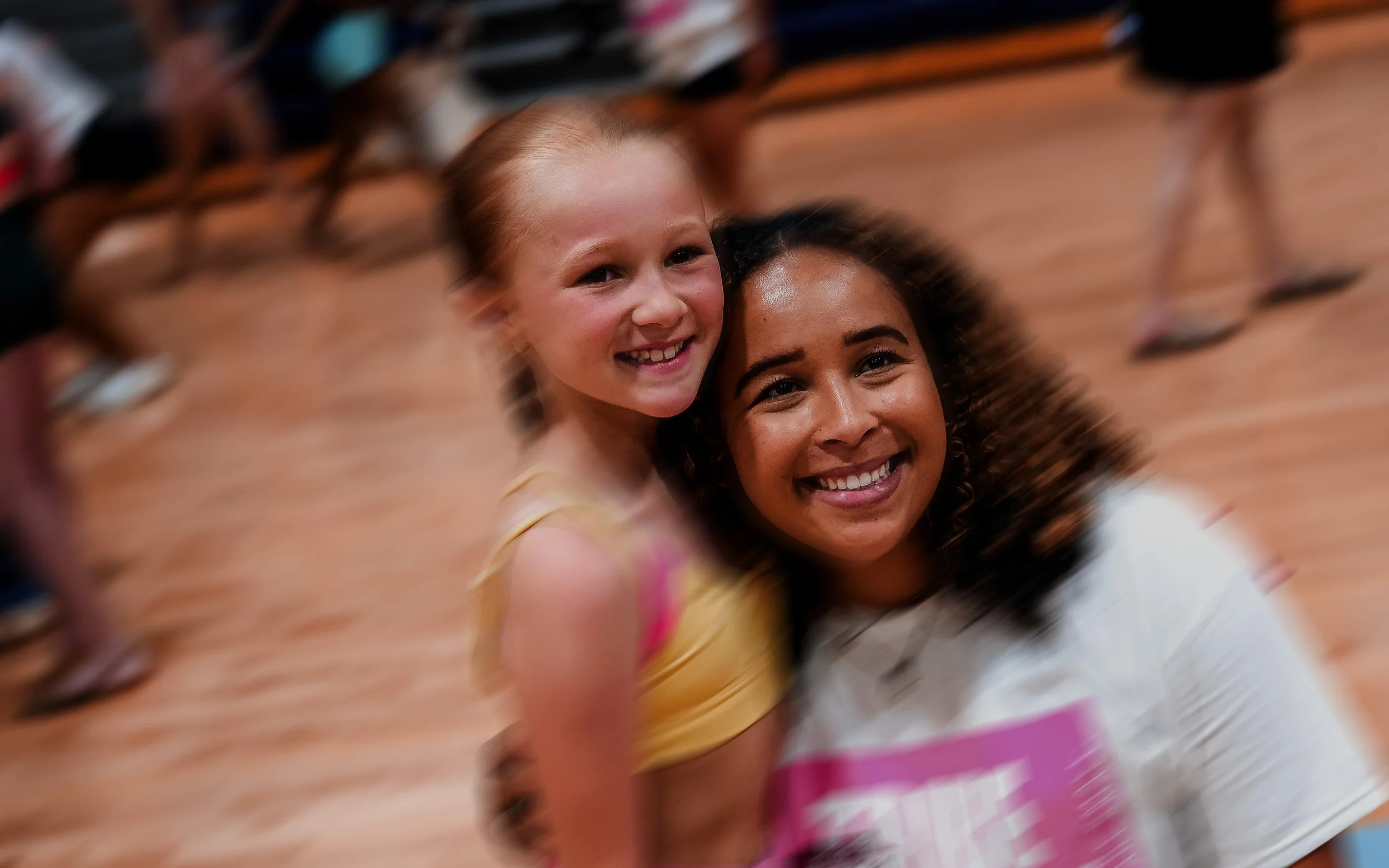 Child smiling with TRIBE 99 faculty