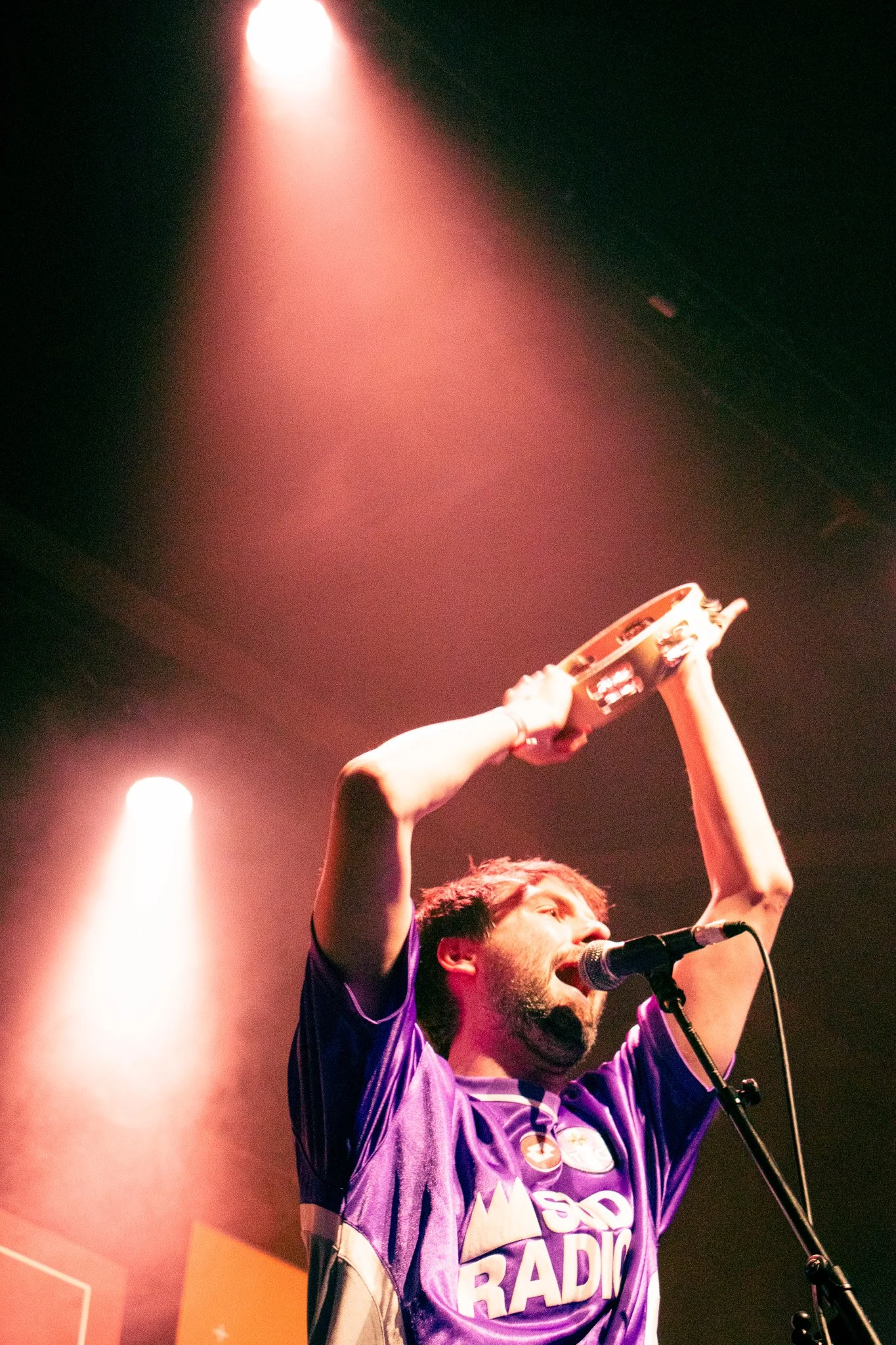 The Silverbacks Irish Band at the RTE choice awards of 2025. A man singing into a microphone while holding a tambourine above his head.