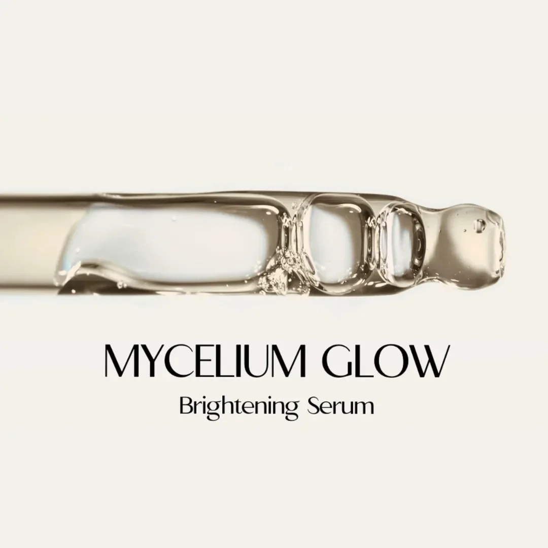 Close-up of Mycelium Glow Brightening Serum dropper with serum droplet