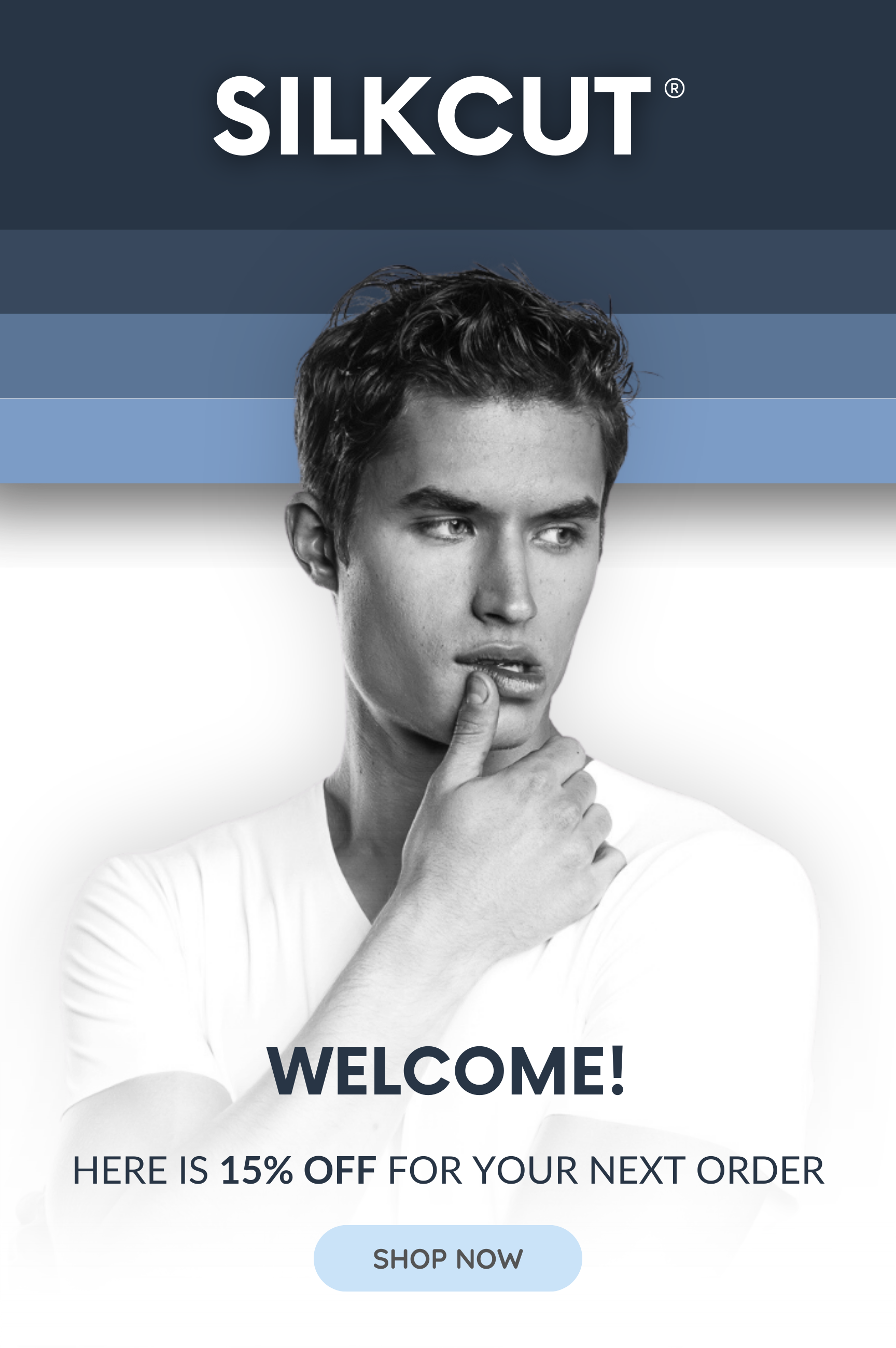 A promotional graphic for SILKCUT featuring a black and white photo of a young man with styled hair, touching his chin, with bold text saying welcome and offering 15% off on the next order, along with a "Shop Now" button.