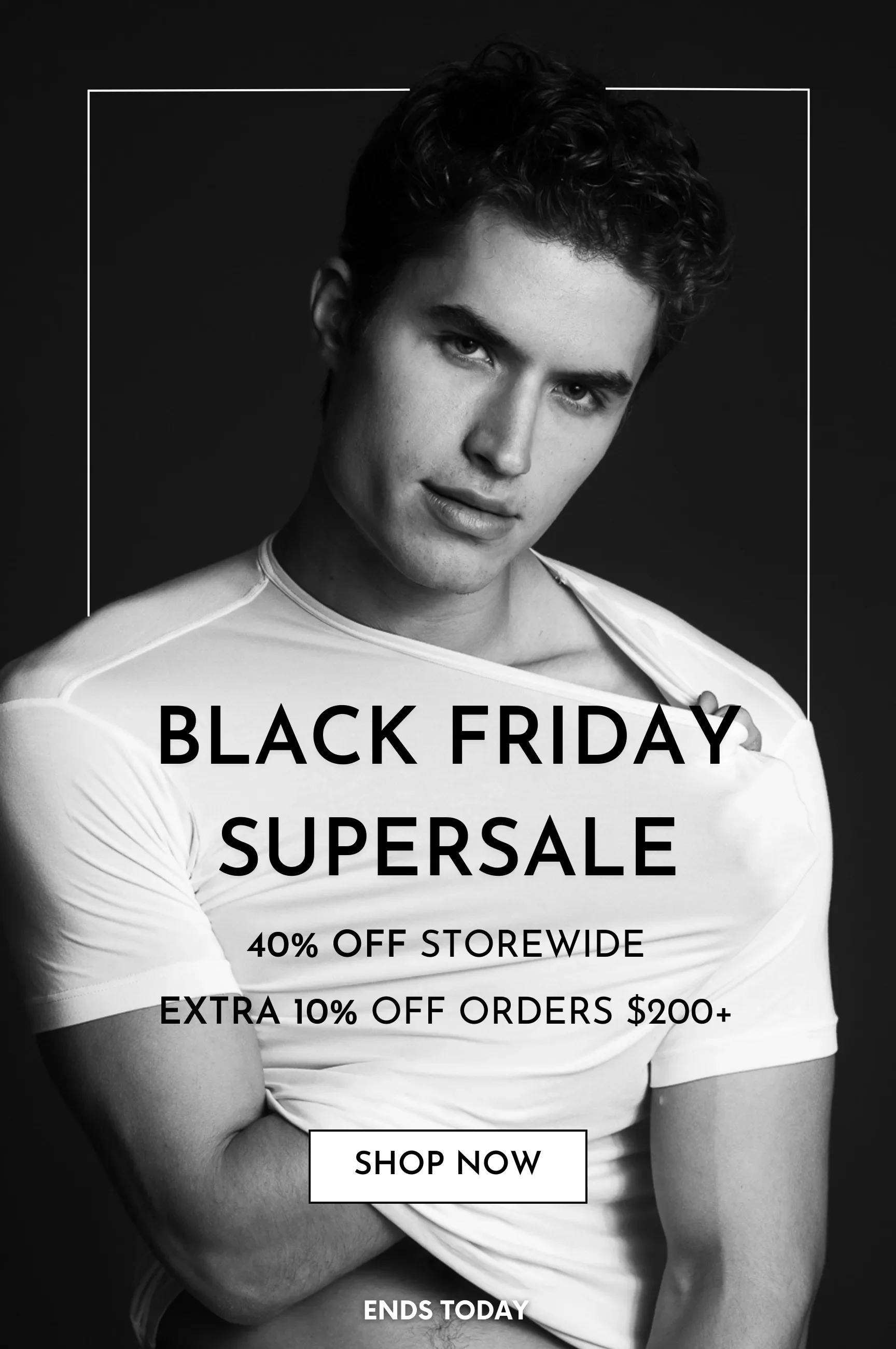 A black and white promotional image featuring a young man with curly hair wearing a white shirt, advertising a Black Friday supersale with 40% off storewide, extra 10% off orders over $200, and a 'Shop Now' button. The sale ends today.