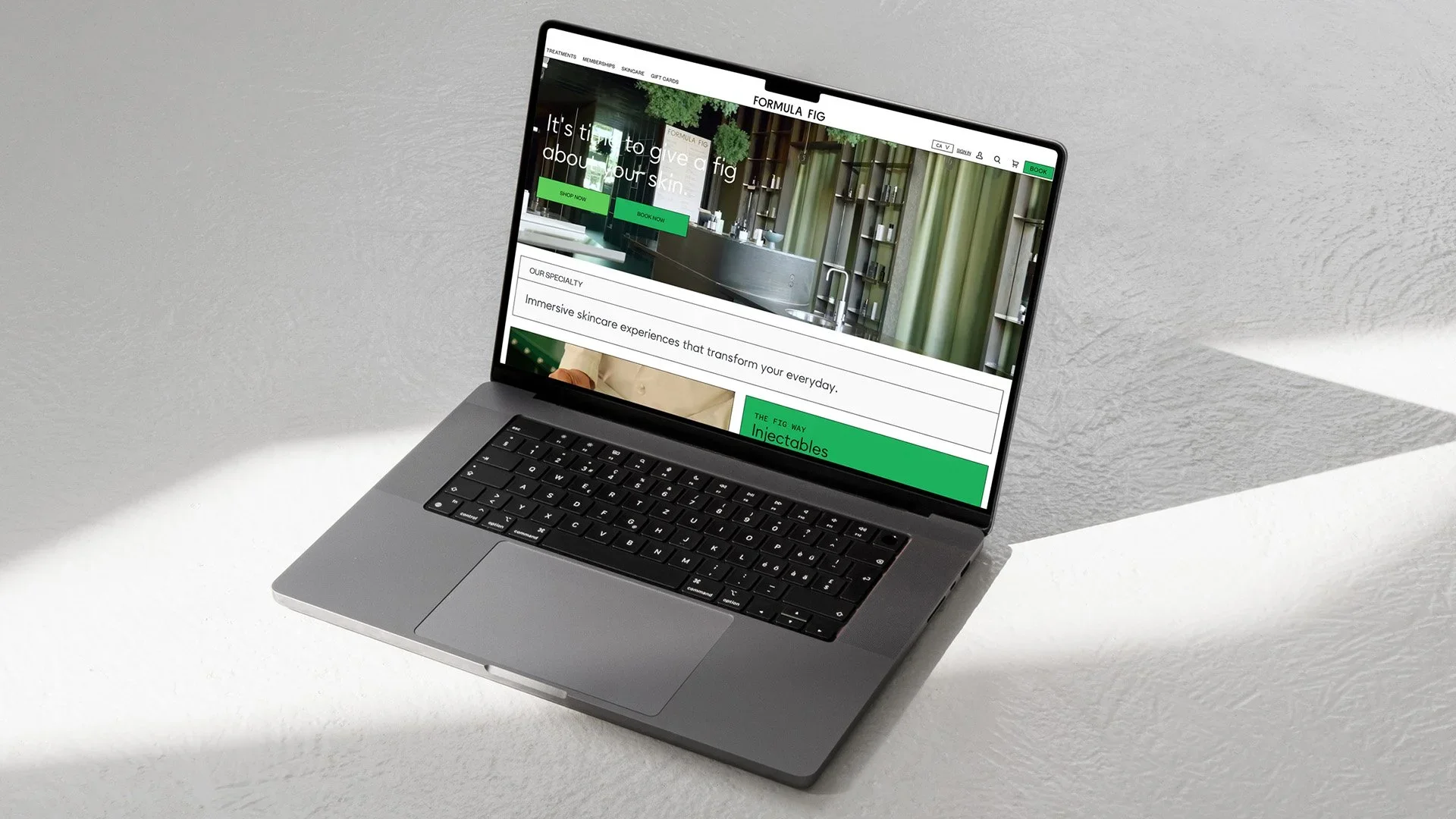 Open laptop on a white surface showing a skincare website with green and white colors