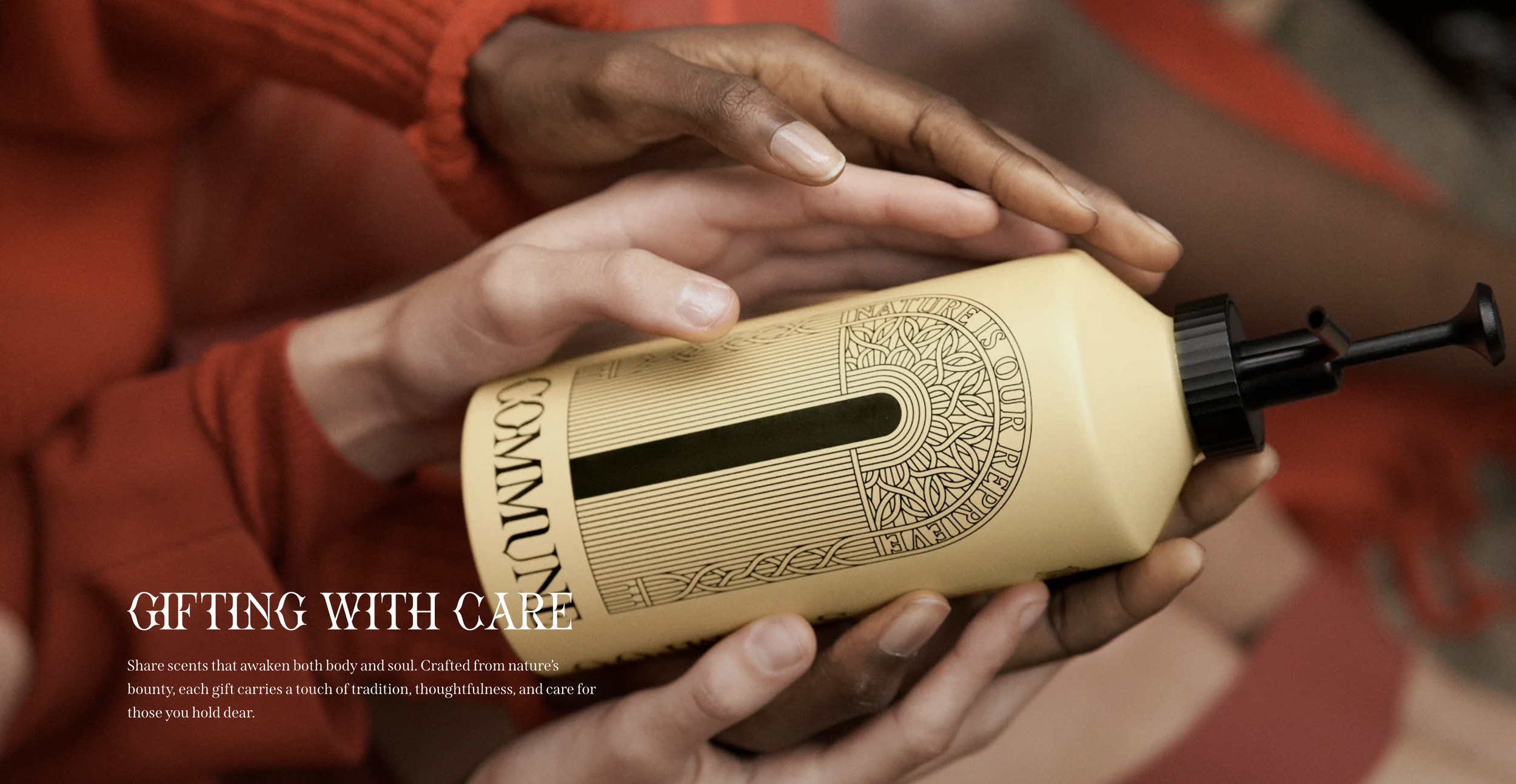A person with dark skin and a red sleeve holds a bottle of lotion or body cream with a black pump. The bottle has decorative text and design, and the background is blurred. The overlay text reads "GIFTING WITH CARE. Share scents that awaken both body and soul. Crafted from nature's bounty, each gift carries a touch of tradition, thoughtfulness, and care for those you hold dear."