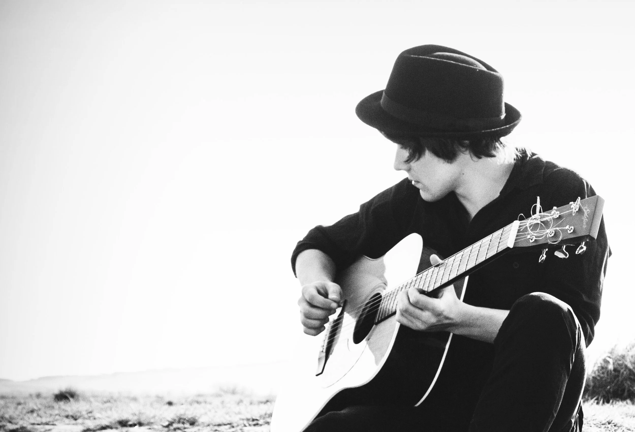 Guitarist and composer Dan Shaux playing acoustic guitar.