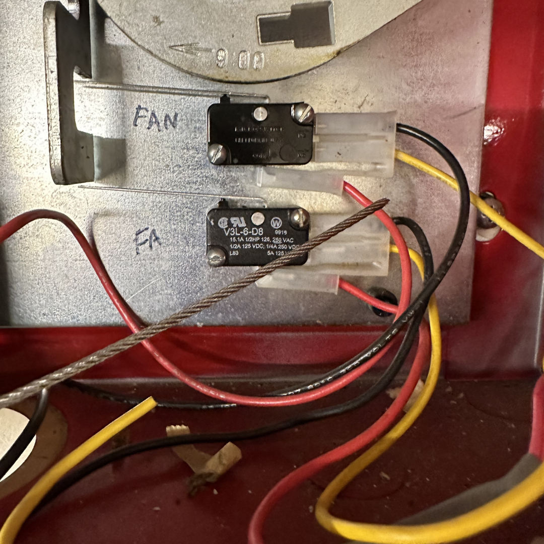 Interior view of an appliance showing wires and two relays mounted on a metallic surface, with handwritten labels 'FAN' and 'FA' next to them.
