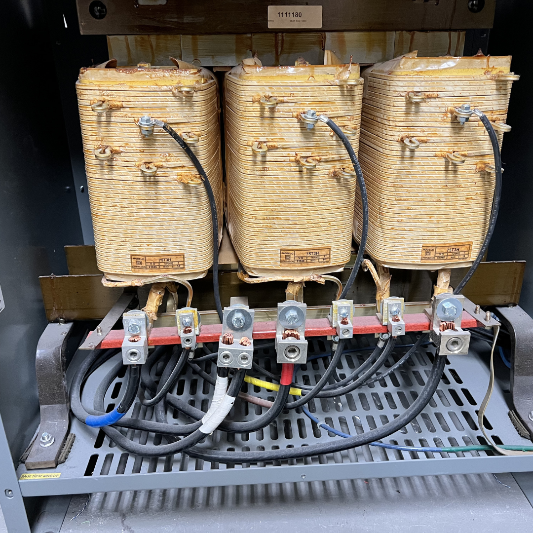 Electromagnetic coils and wiring inside an industrial device or motor.
