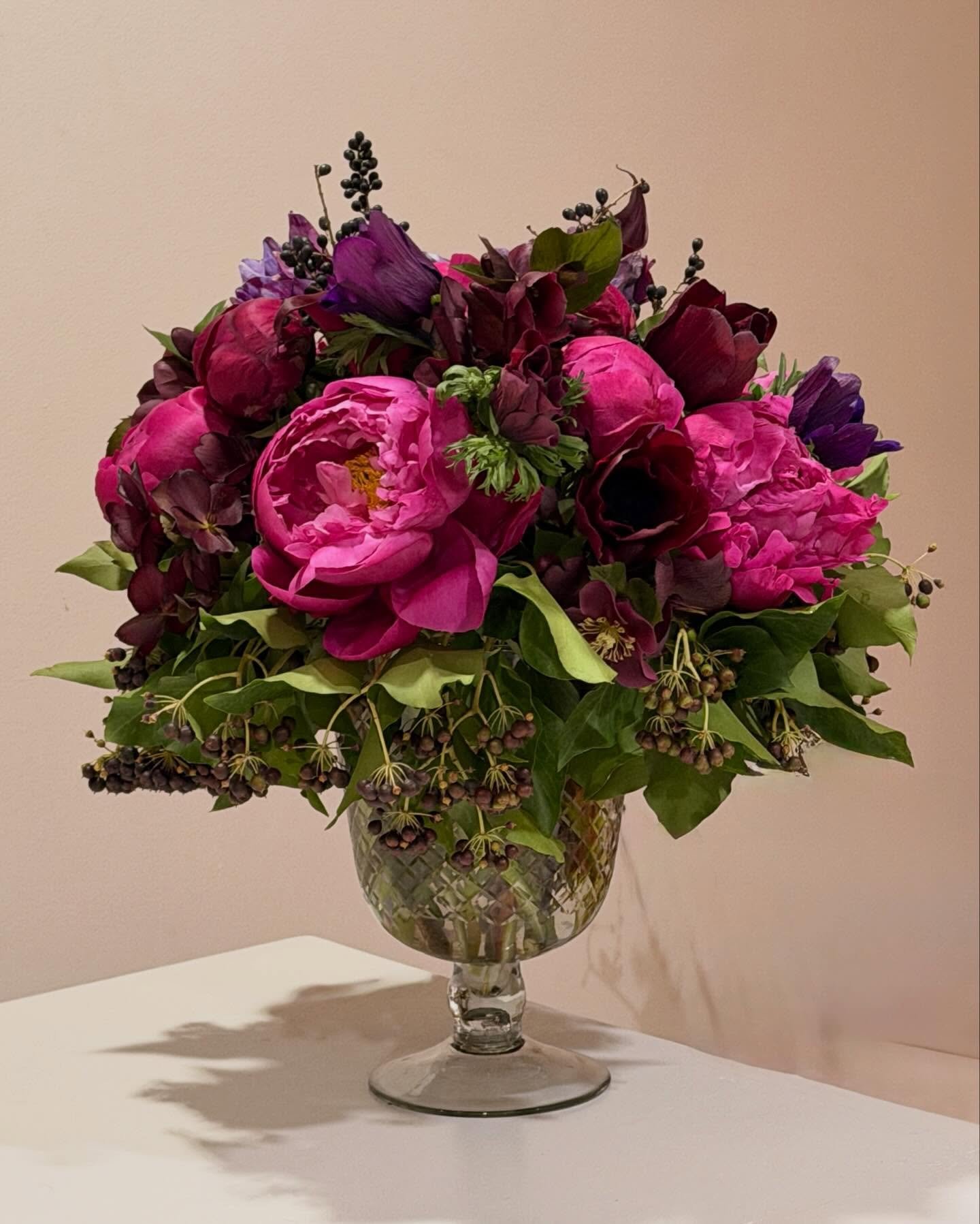 an antique feeling, opulent peony arrangement with deep colored anemones