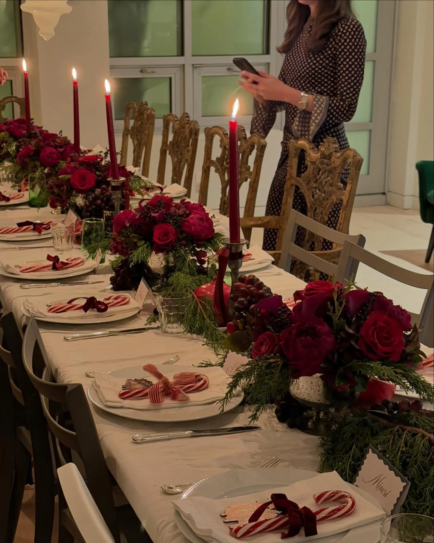 a table dressed in velvet tones: lush blooms, gilded fruit, and winter greens for a candlelit holiday birthday dinner.
