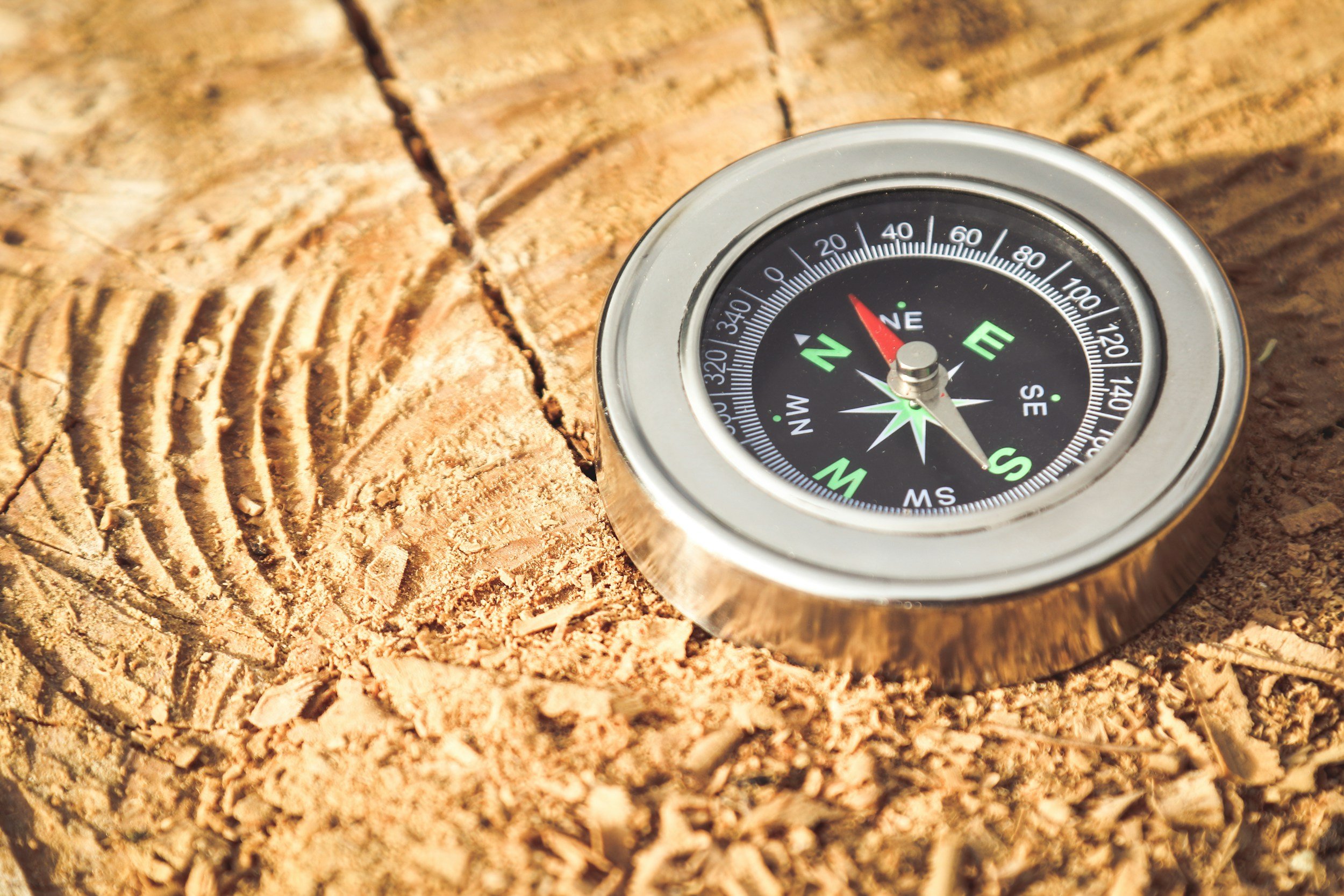 A compass on a wooden surface illustrating how Baseline Strategic Partners' work provides direction.