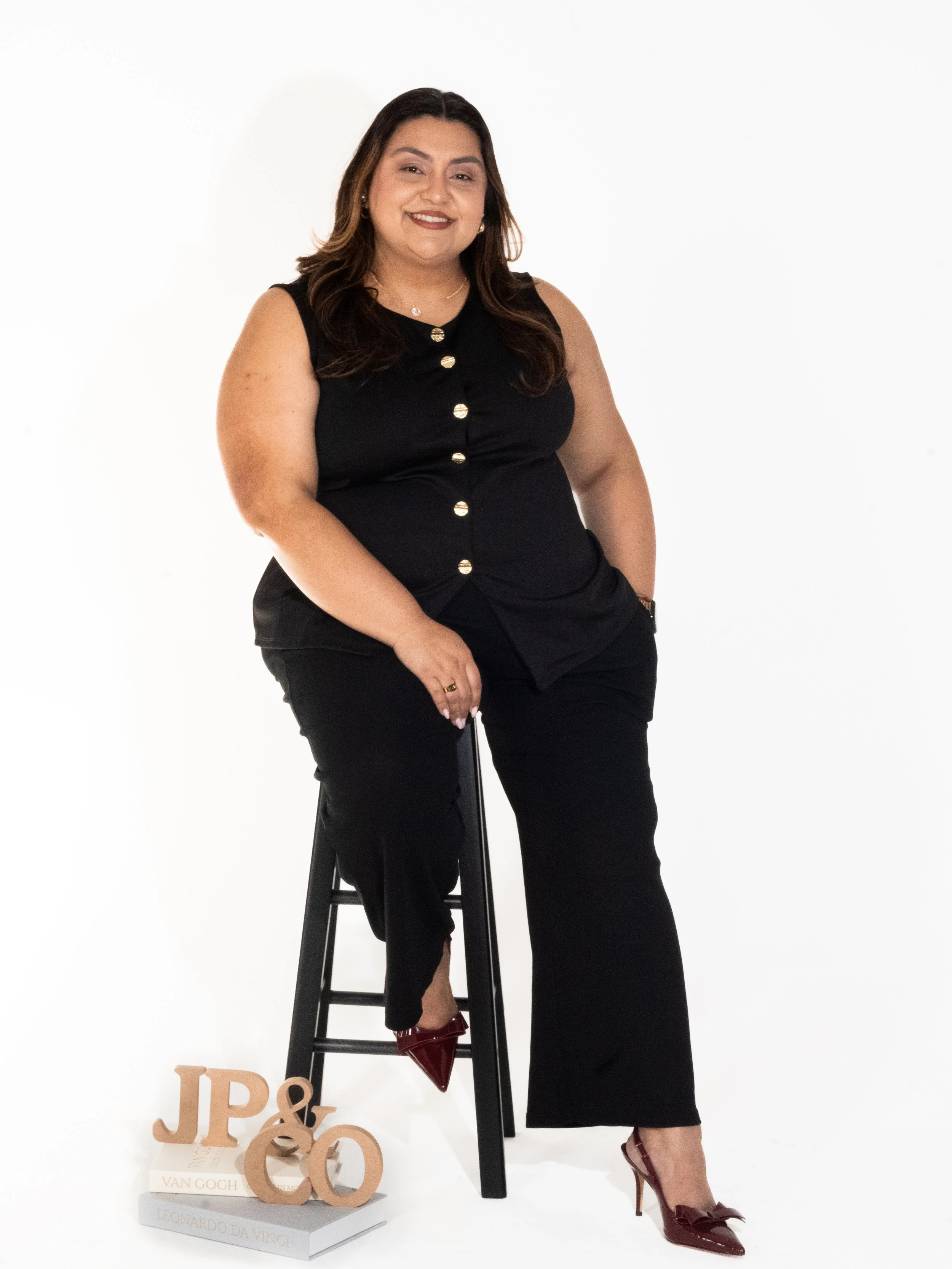 Joanna in a relaxed workspace setting with creative tools around her