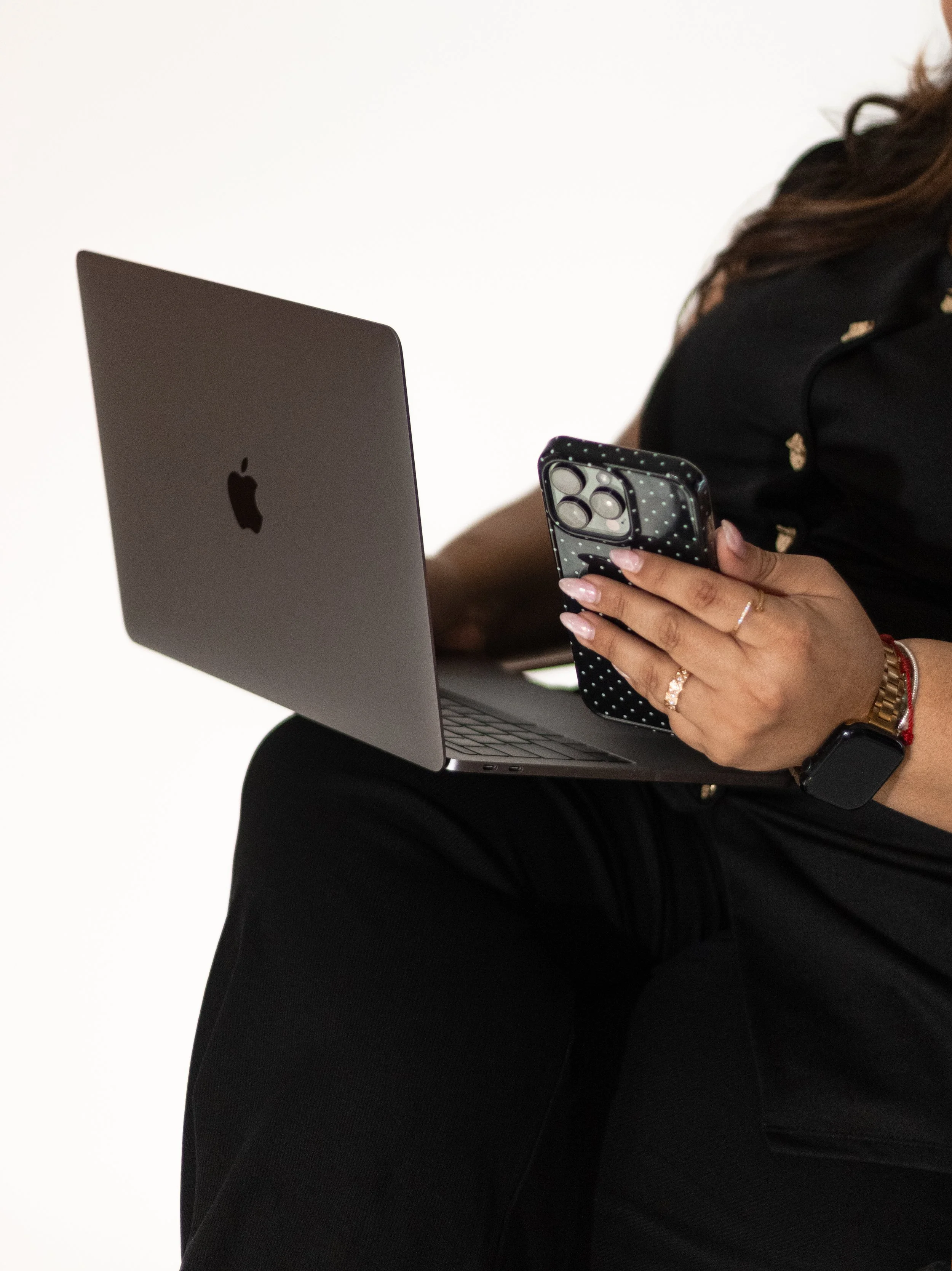 Close up on Joanna holding laptop and phone