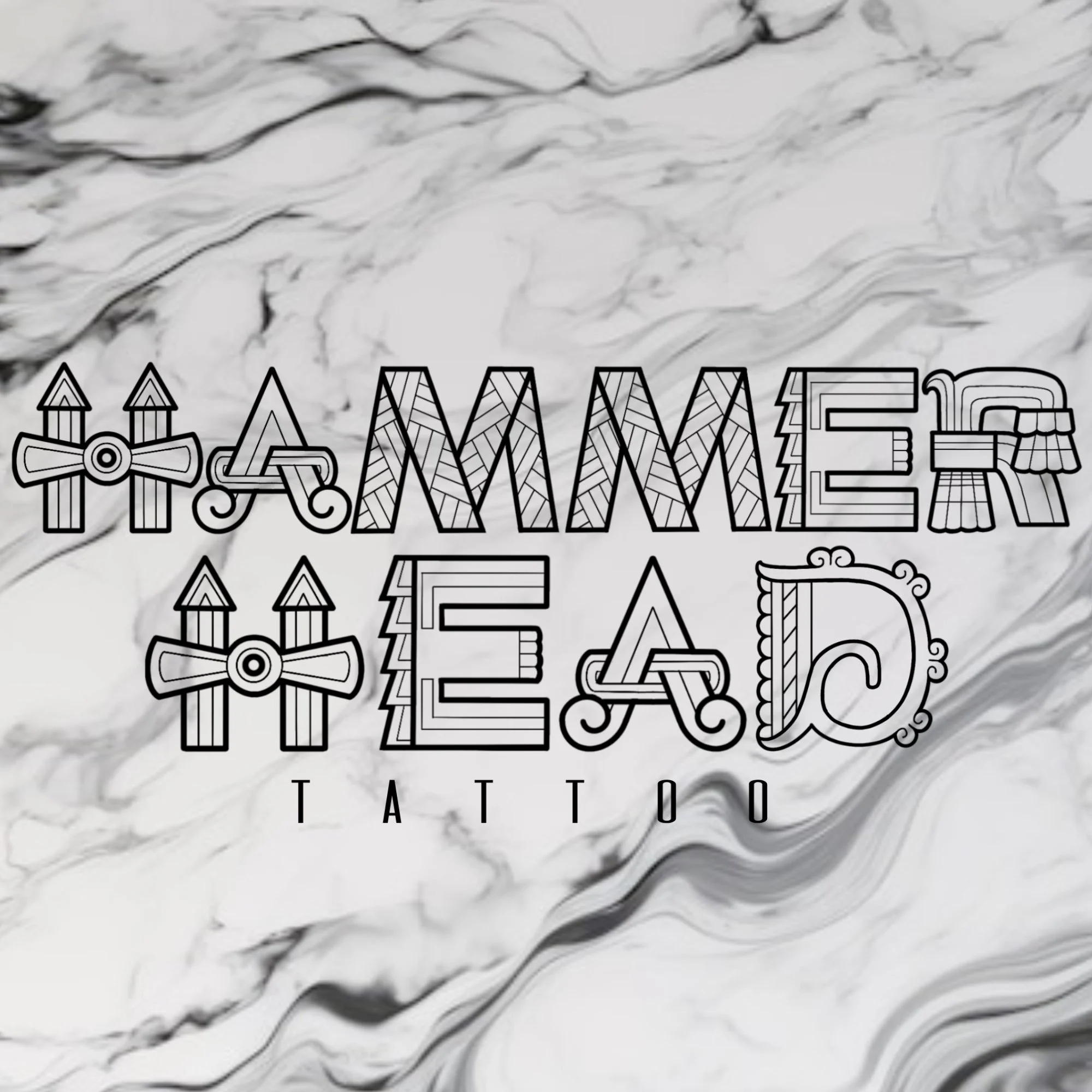 Logo for Amazing E.A. Tattoo featuring stylized letters and tattoo machine icons on a marble background.