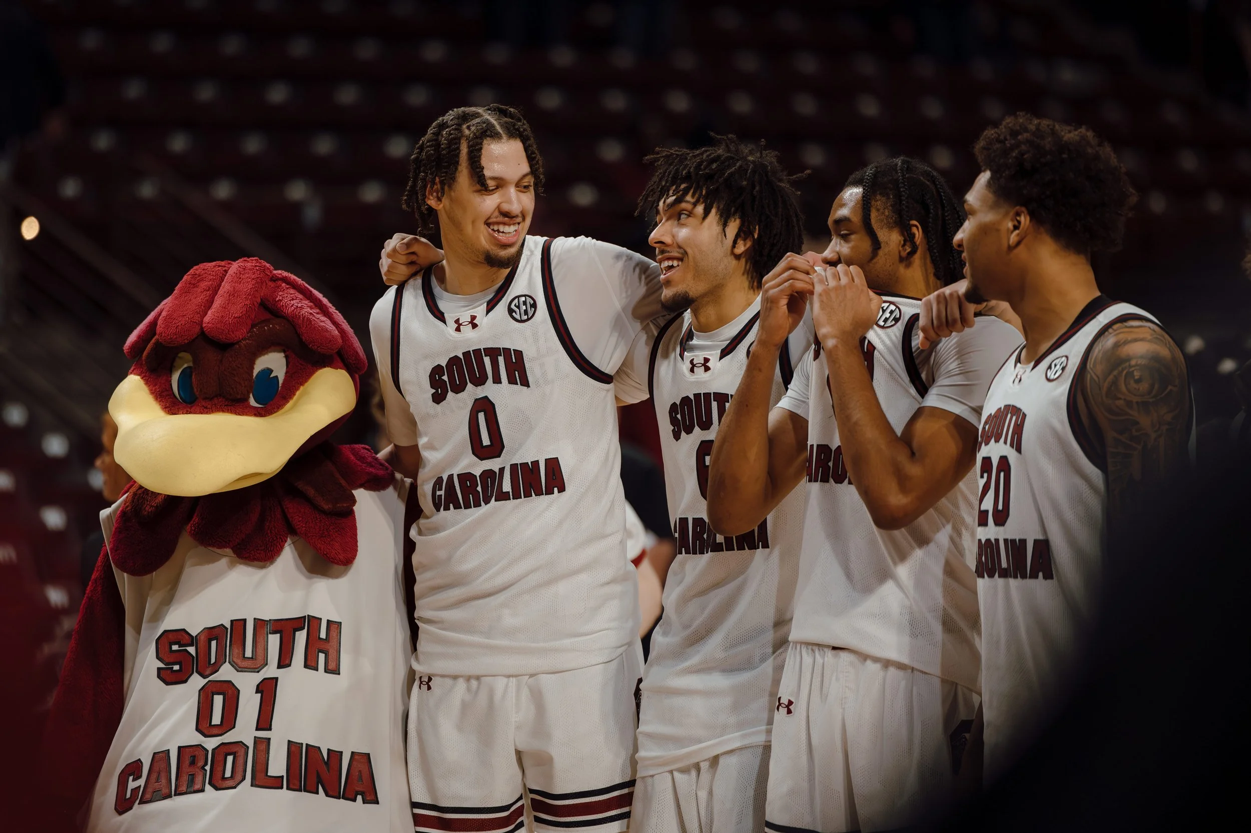 South Carolina Gamecocks players embrace with the team mascot after winning against the Mississippi State Bulldogs at Colonial Life Arena in Columbia, S.C. South Carolina defeated Mississippi State 97–89 on Feb. 21, 2026. 