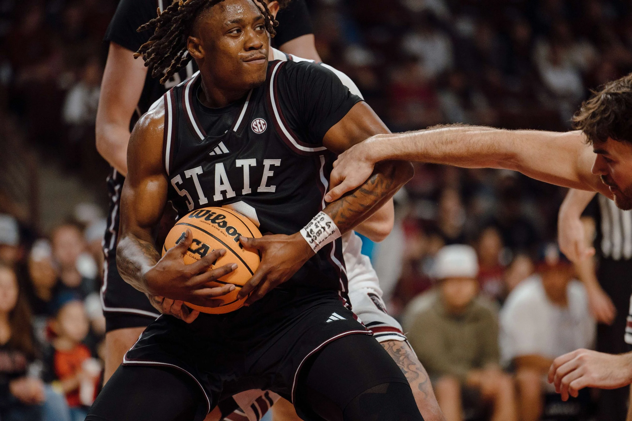 Mississippi State’s Senior Ja’Borri McGhee (#2) secures the ball while defended by South Carolina players during a game against the South Carolina Gamecocks at Colonial Life Arena in Columbia, S.C. South Carolina defeated Mississippi State 97–89 on F