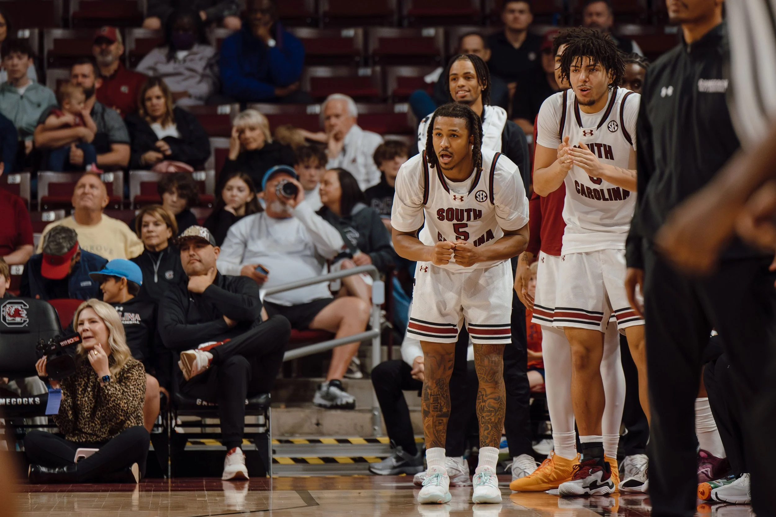 Redshirt Senior Meechie Johnson and Freshman E.J. Walker of the South Carolina Gamecocks reacts from the bench during a game against the Mississippi State Bulldogs at Colonial Life Arena in Columbia, S.C. The Gamecocks defeated Mississippi State 97–8