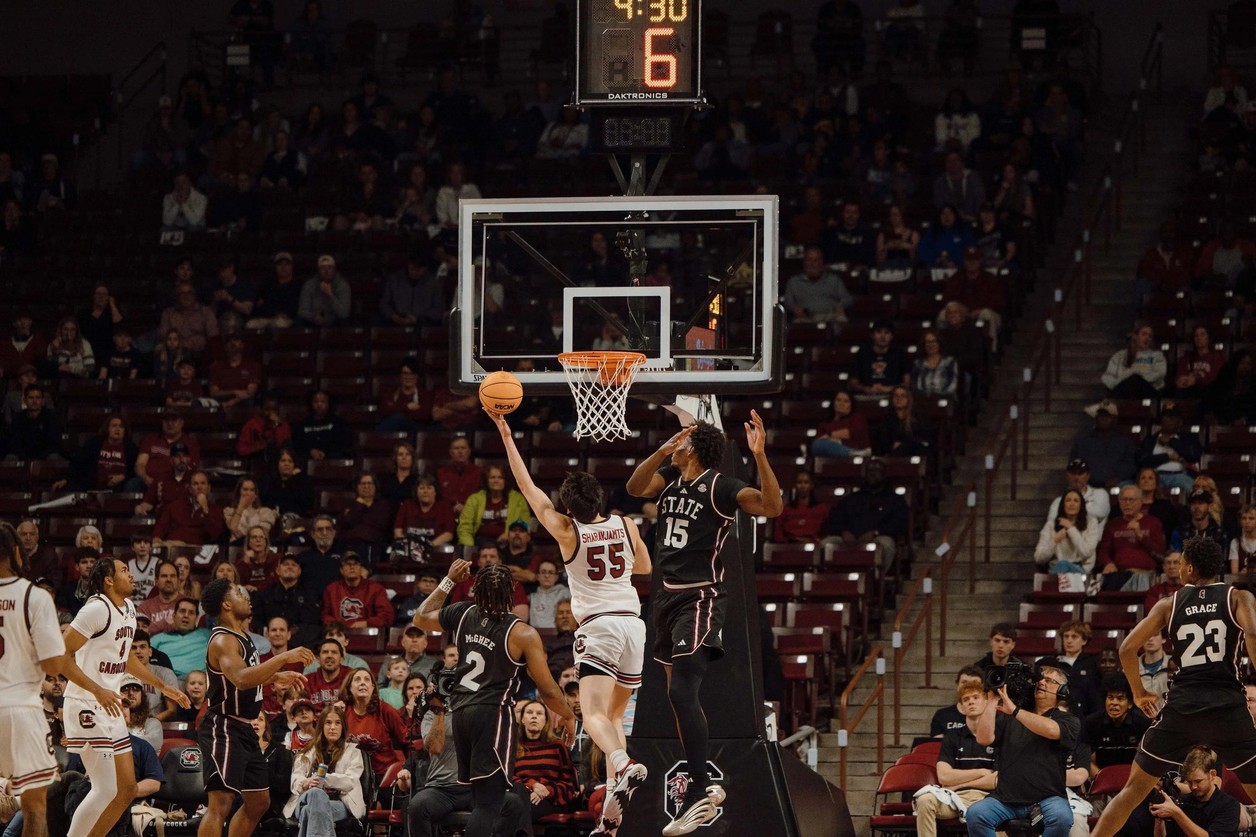 Senior Mike Sharavjamts (#55) of the South Carolina Gamecocks attempts a layup while defended by Mississippi State’s Quincy Ballard (#15) during a game at Colonial Life Arena in Columbia, S.C. South Carolina defeated Mississippi State 97–89 on Feb. 2