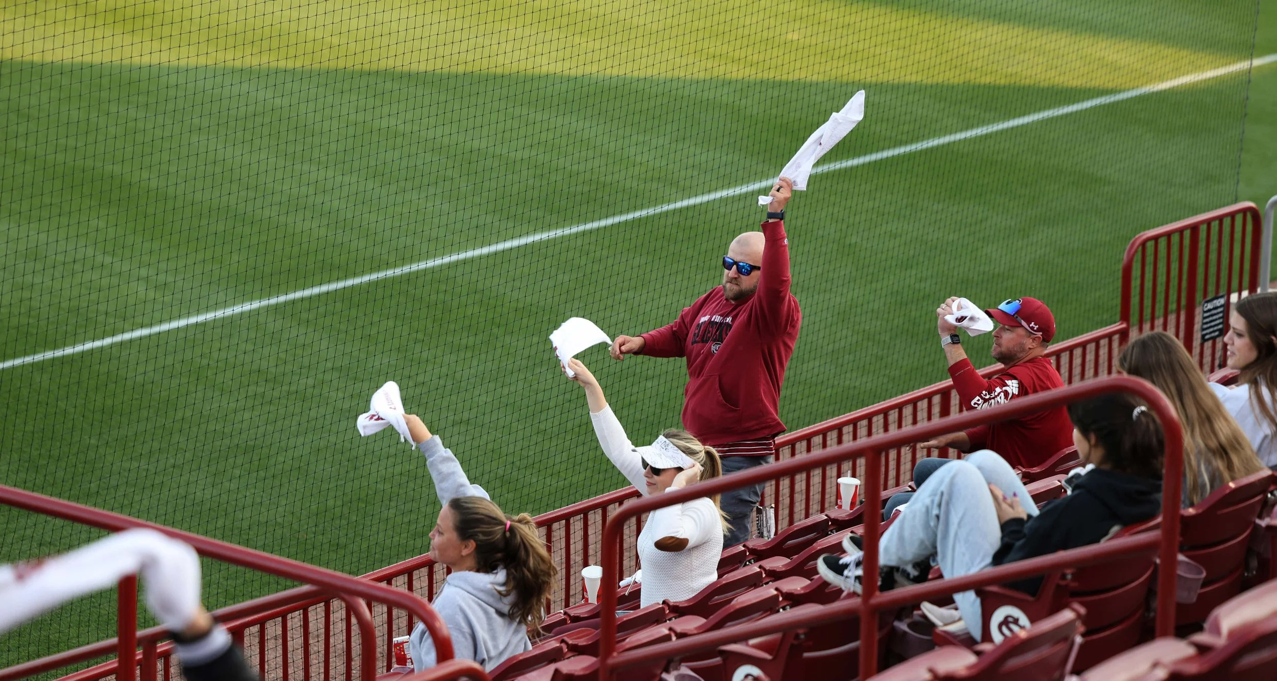 South Carolina fan Jade Roy waves his rally towel alongside other Gamecock fans after a successful play during the softball team's game against Charleston Southern at Carolina Softball Stadium on April 9, 2025. A South Carolina native with a softball